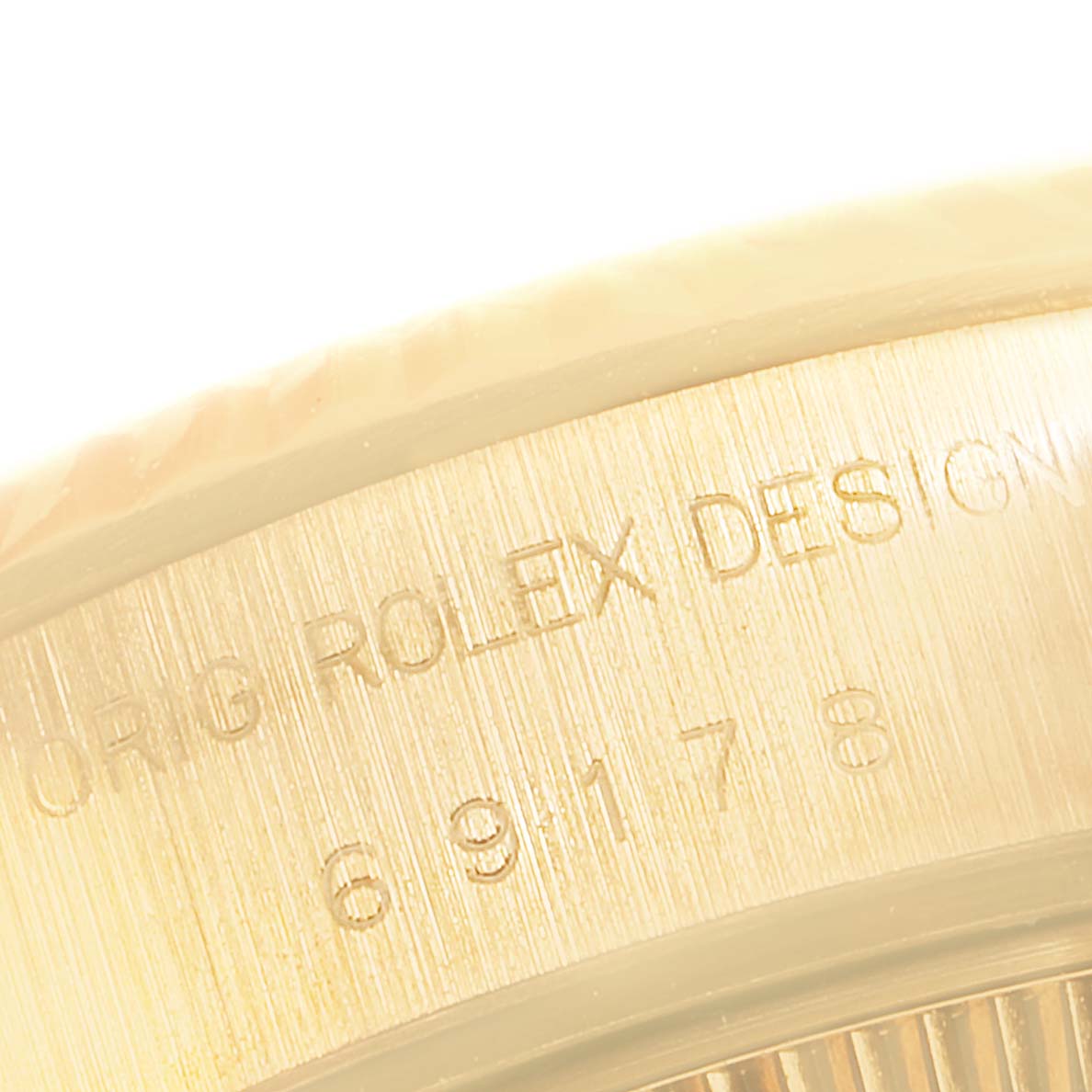 The image shows the side engraving details of a Rolex President 69178 Women's Yellow Gold Champagne Dial 69178 Women's Yellow Gold Champagne Dial watch case, highlighting its design and model number.