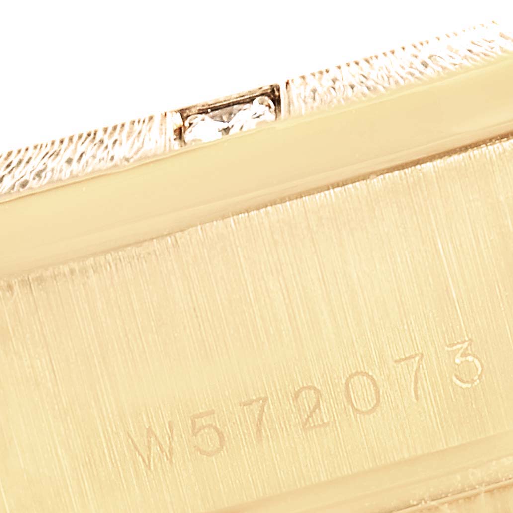 This image shows a close-up of a part of the Rolex President 69288 Women
s Yellow Gold White Dial 69288 Women
s Yellow Gold White Dial model, focusing on the engraved serial number.