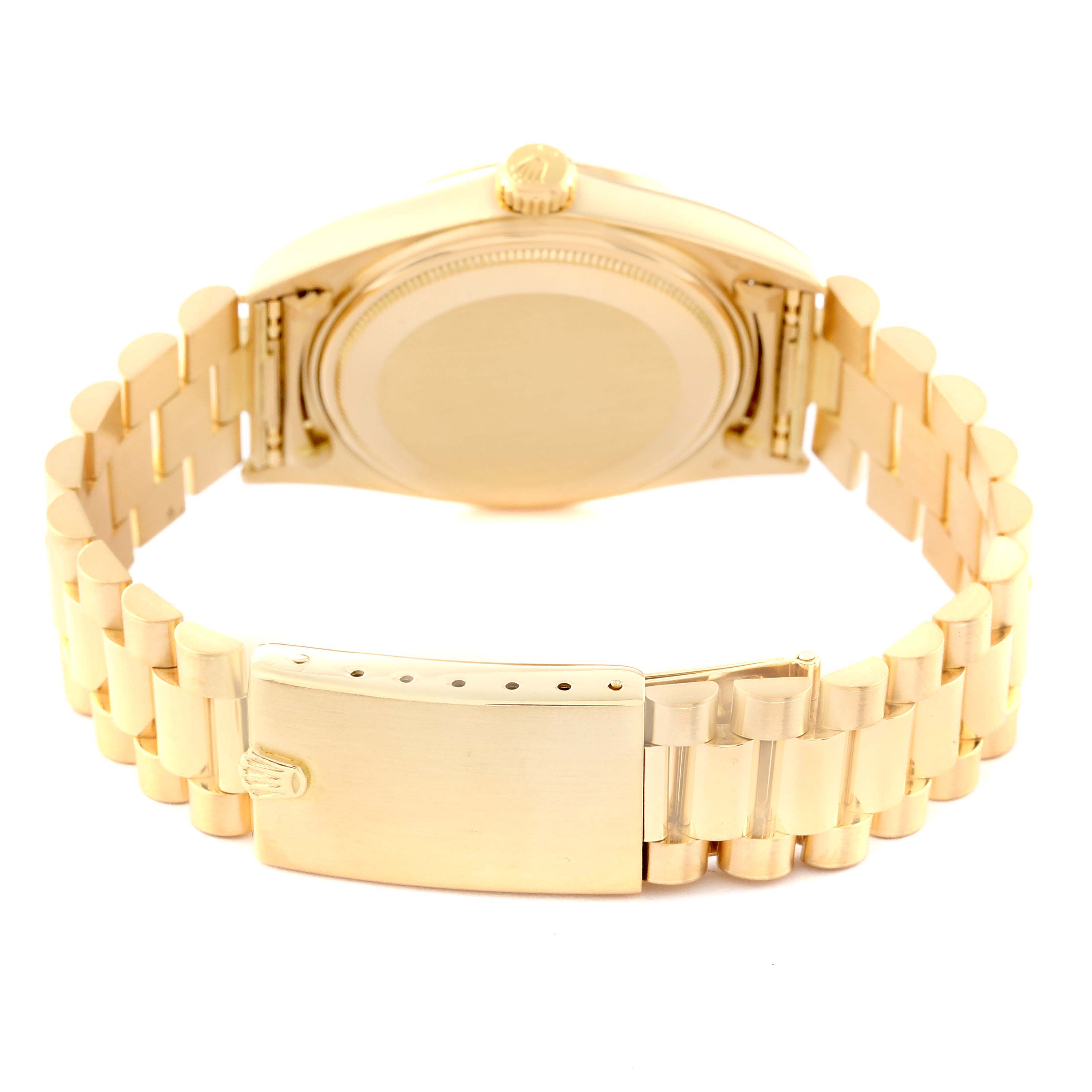 The image shows the back view of a Vintage Collection Rolex watch, focusing on the case back and the clasp of the gold bracelet.