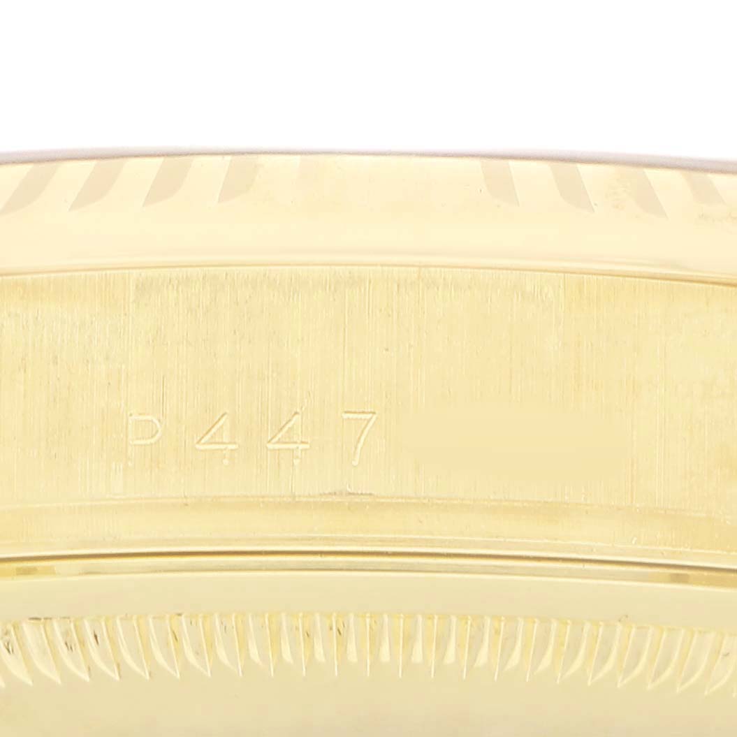The image shows a close-up of the side of a Rolex President 118238 Men's Yellow Gold Silver Dial watch, focusing on the fluted bezel and engraved details.