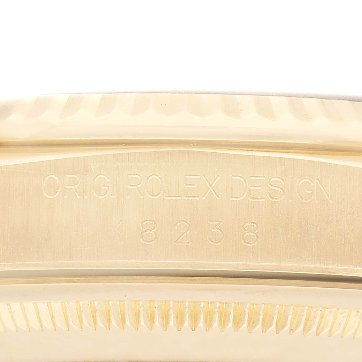 The image shows a close-up of the case side beneath the bezel of a Rolex President 18238 Men's Yellow Gold Champagne Dial 18238 Men's Yellow Gold Champagne Dial model, highlighting the engraved design number.