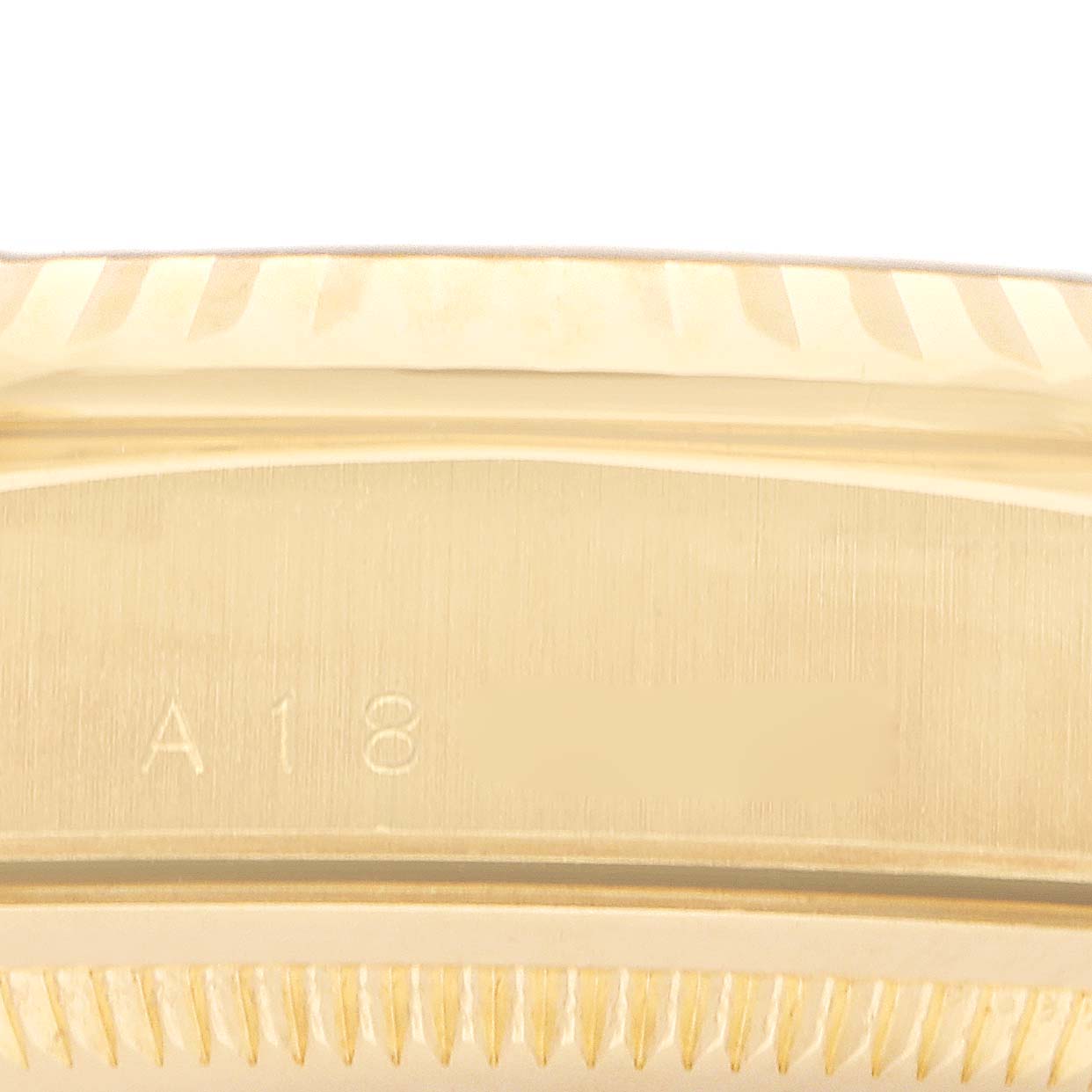 The image shows a close-up of the Rolex President 18238 Men's Yellow Gold Champagne Dial 18238 Men's Yellow Gold Champagne Dial model's case edge, showcasing the branding and part of the fluted bezel.