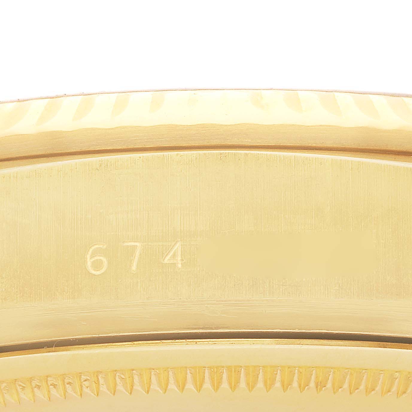 The image shows a close-up of the gold fluted bezel of a Rolex President 18038 Men's Yellow Gold Champagne Dial 18038 Men's Yellow Gold Champagne Dial model, including part of the watch's edge.