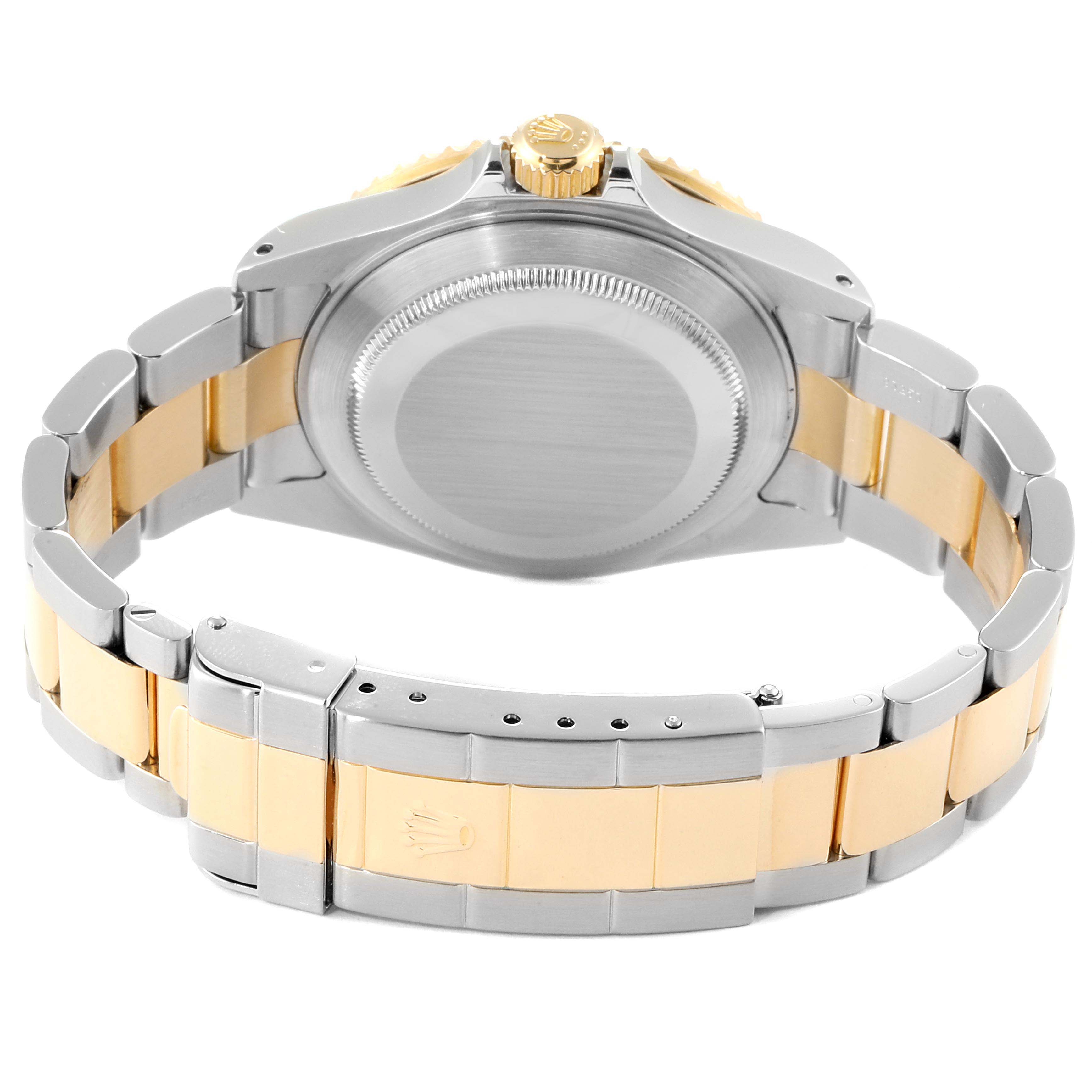 This Rolex Submariner 16613 Men
s Steel and Gold (two tone) Blue Dial 16613 Men
s Steel and Gold (two tone) Blue Dial watch is shown from the rear, displaying the case back, crown, and two-tone bracelet.