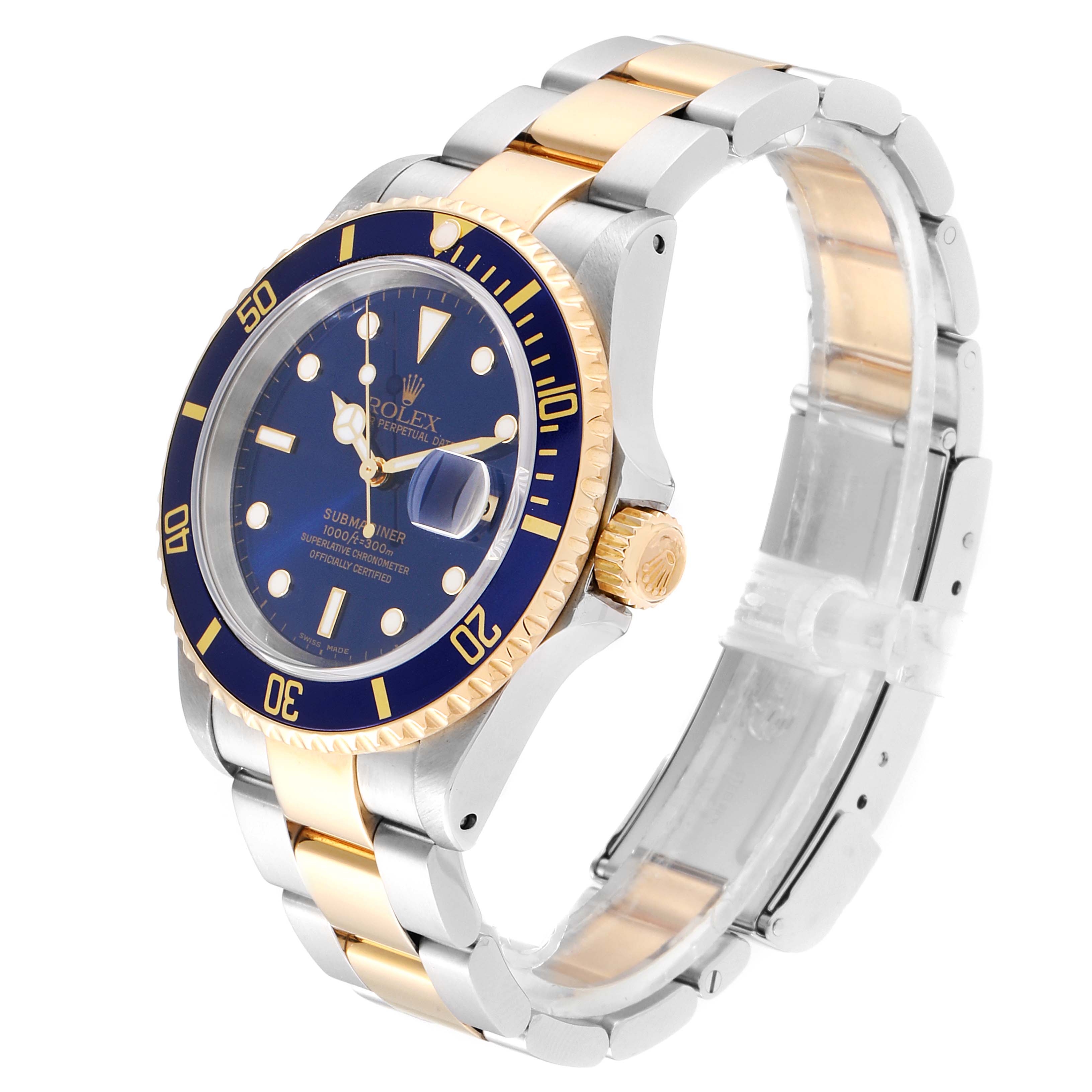 The image shows a Rolex Submariner 16613 Men
s Steel and Gold (two tone) Blue Dial 16613 Men
s Steel and Gold (two tone) Blue Dial watch at a three-quarter angle, highlighting its blue dial, bezel, and the two-tone metal bracelet.