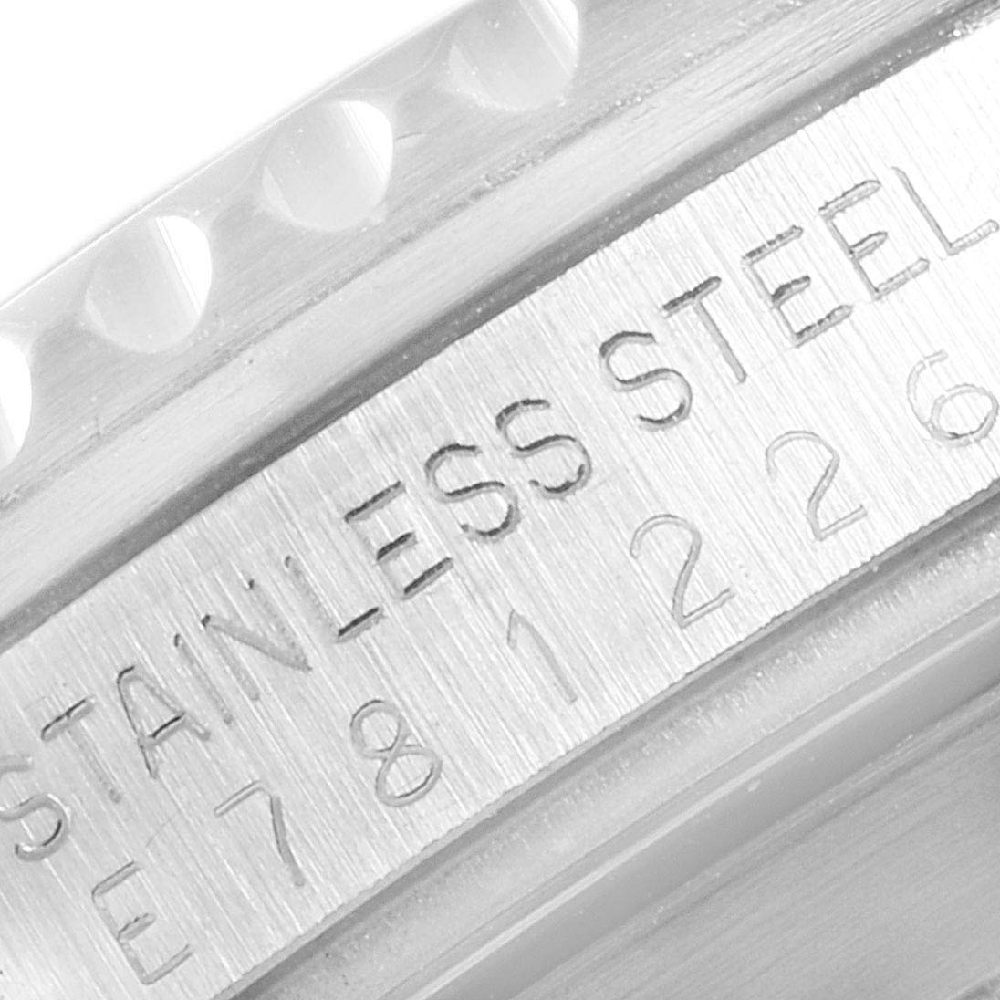 This image shows a close-up of the engraved serial number and "STAINLESS STEEL" marking on the case of a Rolex Submariner 16610 Men
s Stainless Steel Black Dial 16610 Men
s Stainless Steel Black Dial.