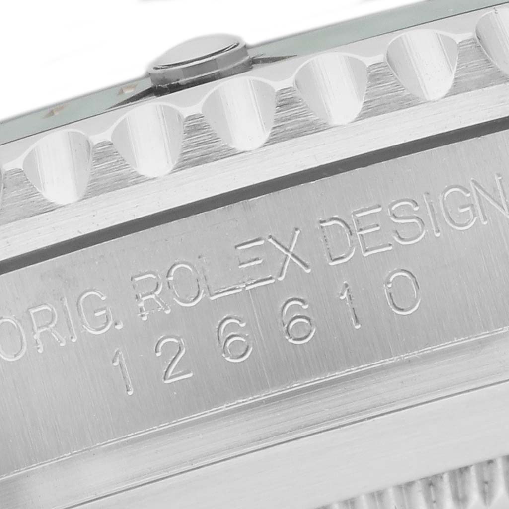 The image shows a close-up of the side of the Rolex Submariner 126610LV Men's Stainless Steel Black Dial, featuring engraved text and the edge of the bezel.