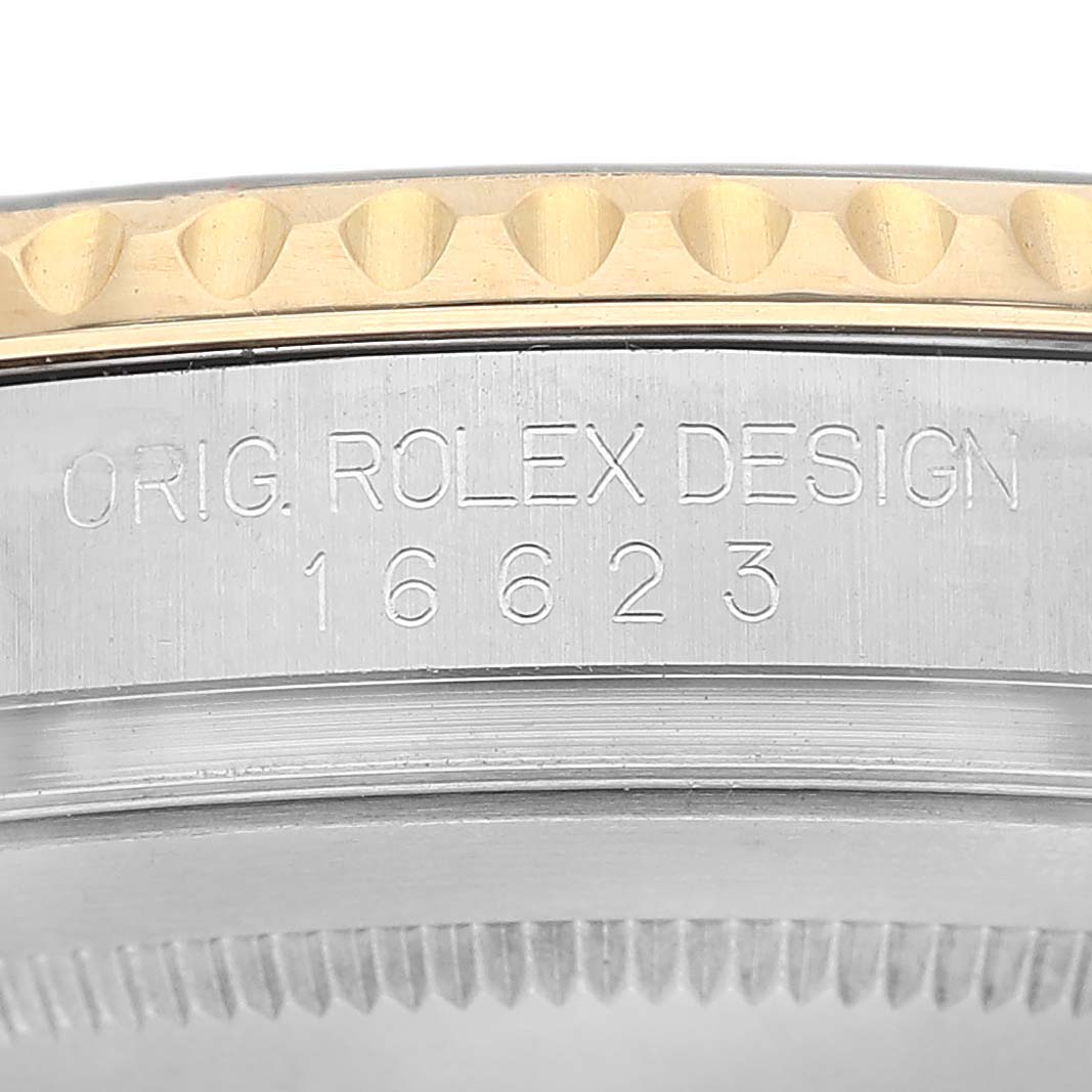 The image shows a close-up of the Rolex Yacht-Master 16623 Men's Steel and Gold (two tone) Blue Dial's engraved watch case side with bezel detail.