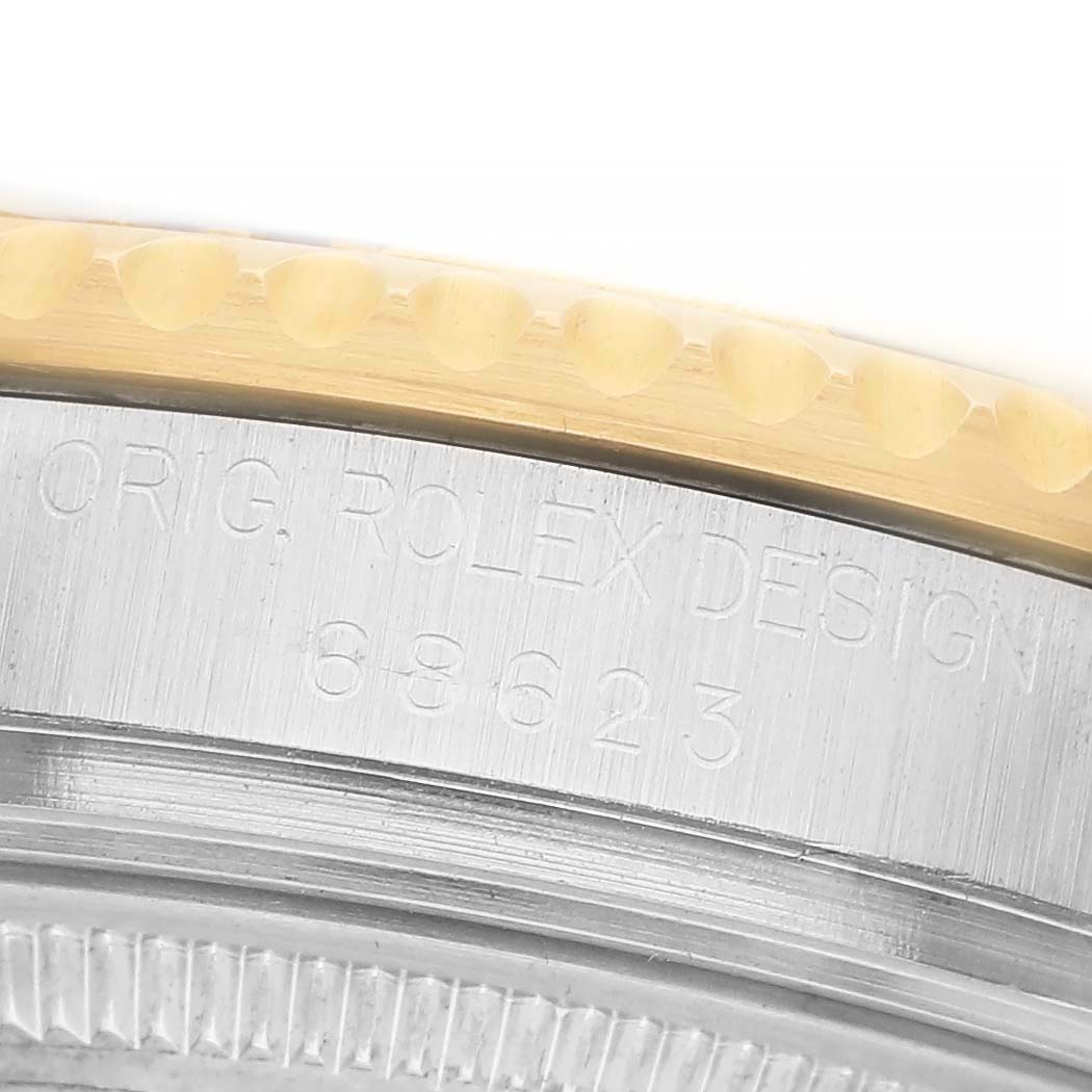 The image shows a close-up of the side of a Rolex Yacht-Master 68623 Men's Steel and Gold (two tone) Blue Dial watch, highlighting the bezel and engraved model details.