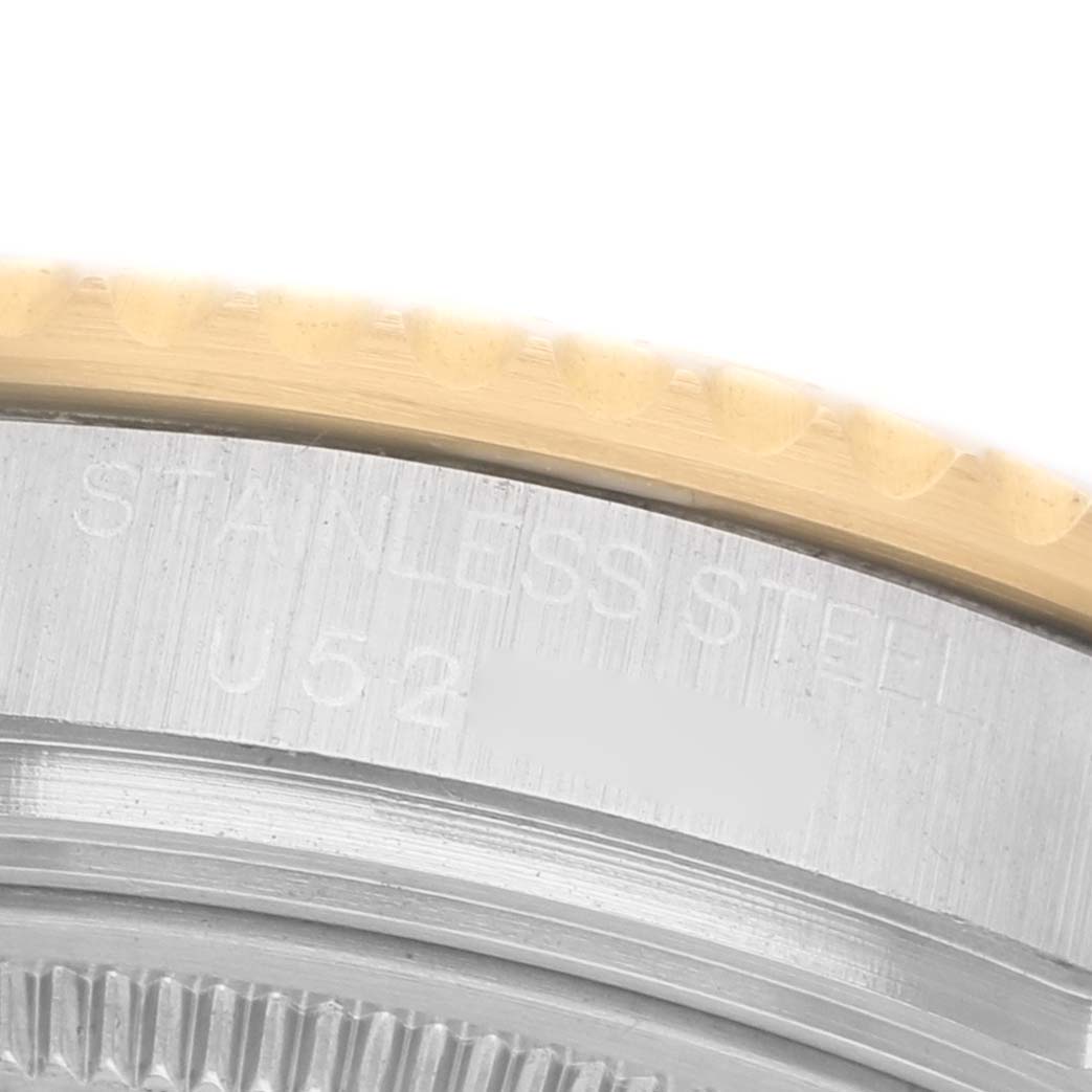 The image shows a close-up of the edge of the bezel and case back of a Rolex Yacht-Master 68623 Men's Steel and Gold (two tone) Blue Dial watch, highlighting the engravings.