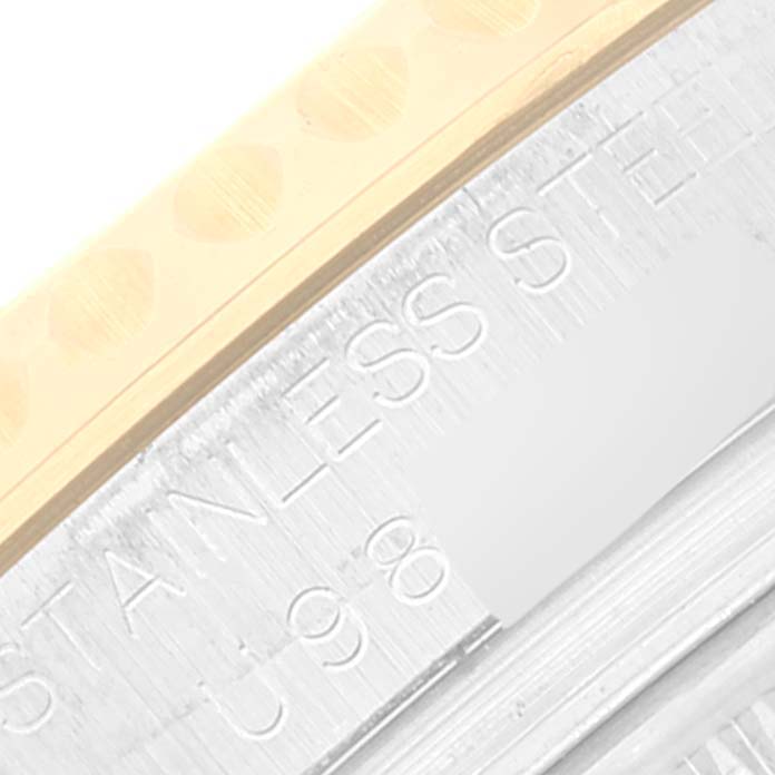 This close-up angle shows the engraved "STAINLESS STEEL" text and part of a Rolex Yacht-Master 168623 Men's Steel and Gold (two tone) Blue Dial 168623 Men's Steel and Gold (two tone) Blue Dial watch case.