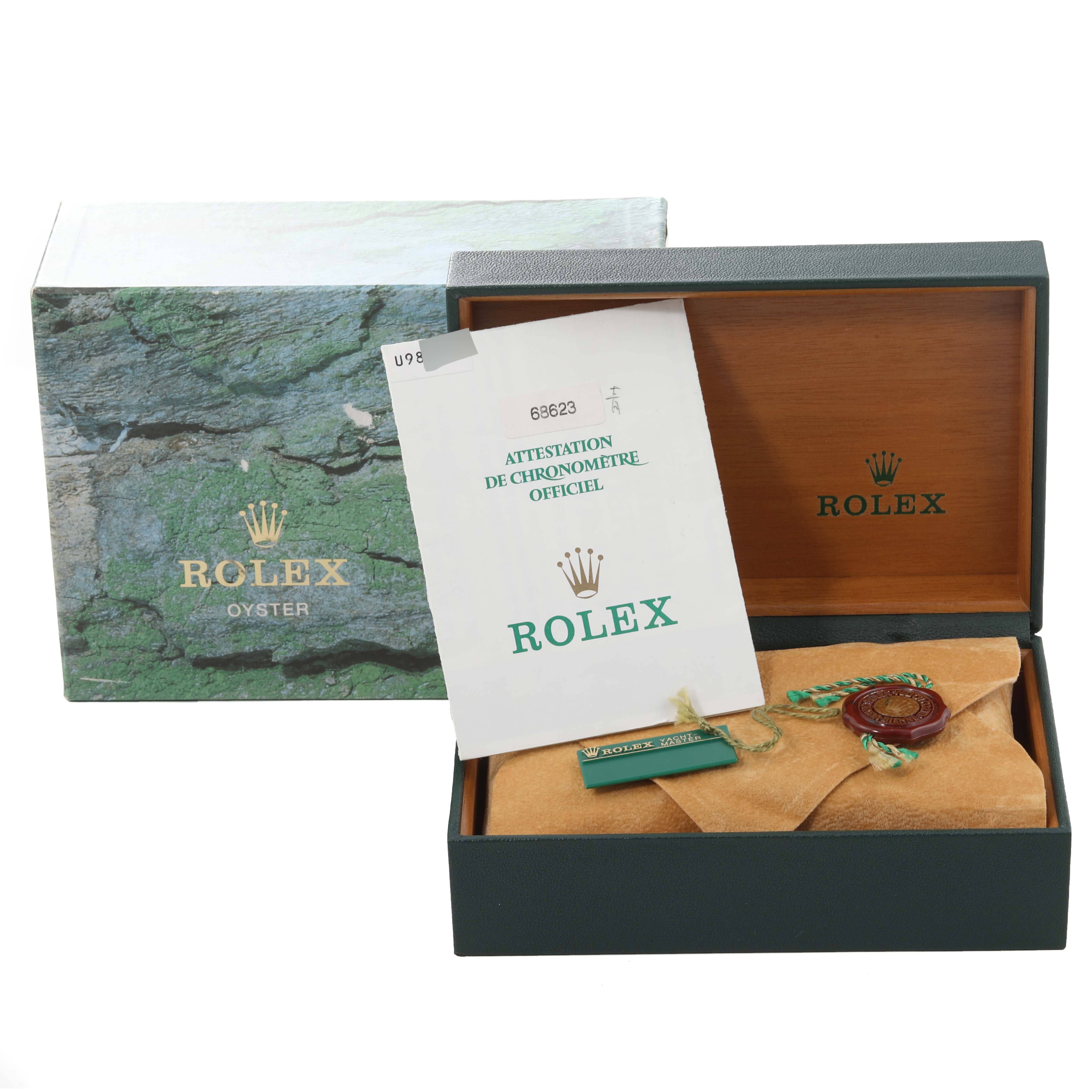 The image shows the packaging, certification, and accessories for a Rolex Yacht-Master 168623 Men's Steel and Gold (two tone) Blue Dial 168623 Men's Steel and Gold (two tone) Blue Dial watch.