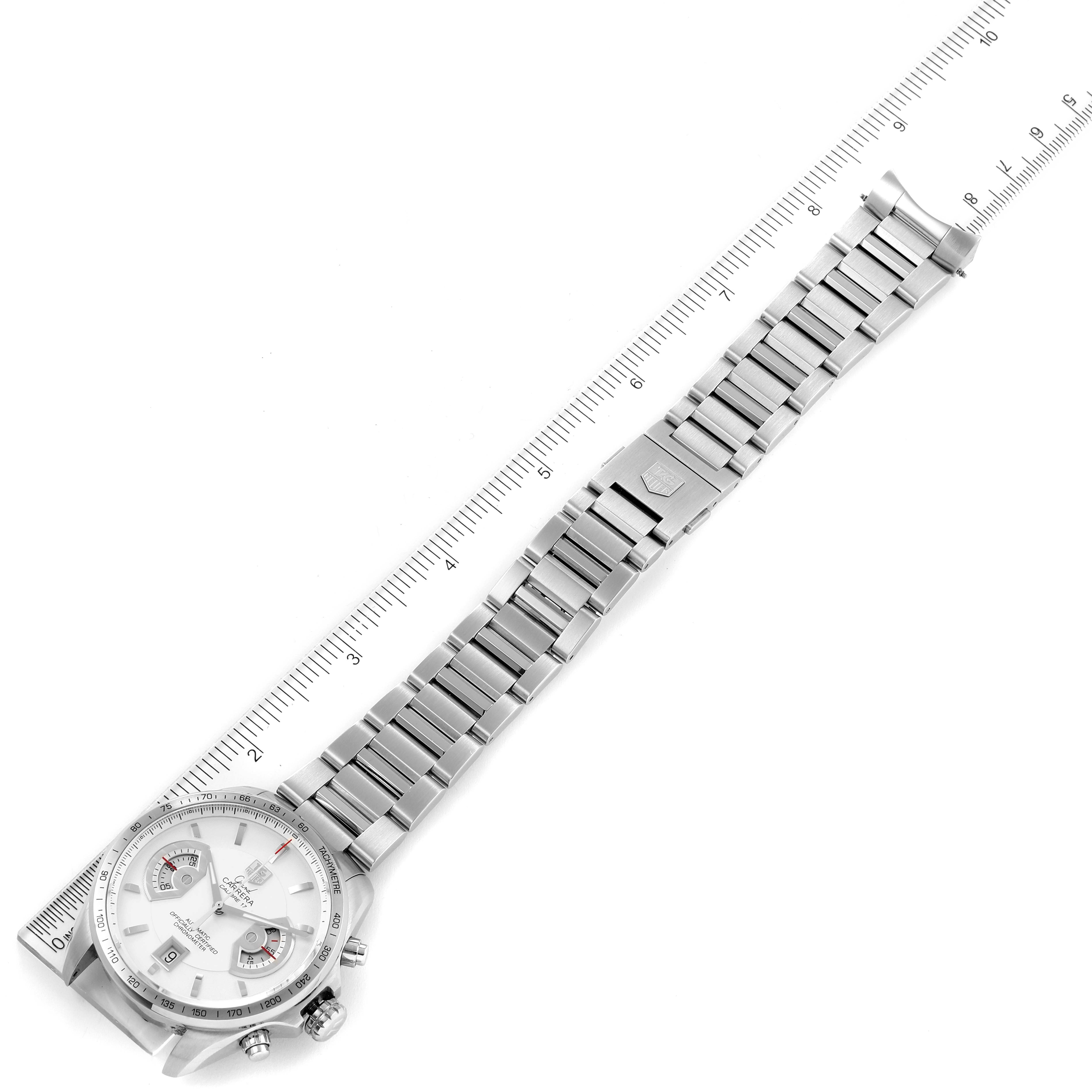 This image shows a top view of a Tag Heuer Carrera CAV511B Men's Stainless Steel Silver Dial CAV511B Men's Stainless Steel Silver Dial watch, highlighting its stainless steel band and face placed next to a ruler.