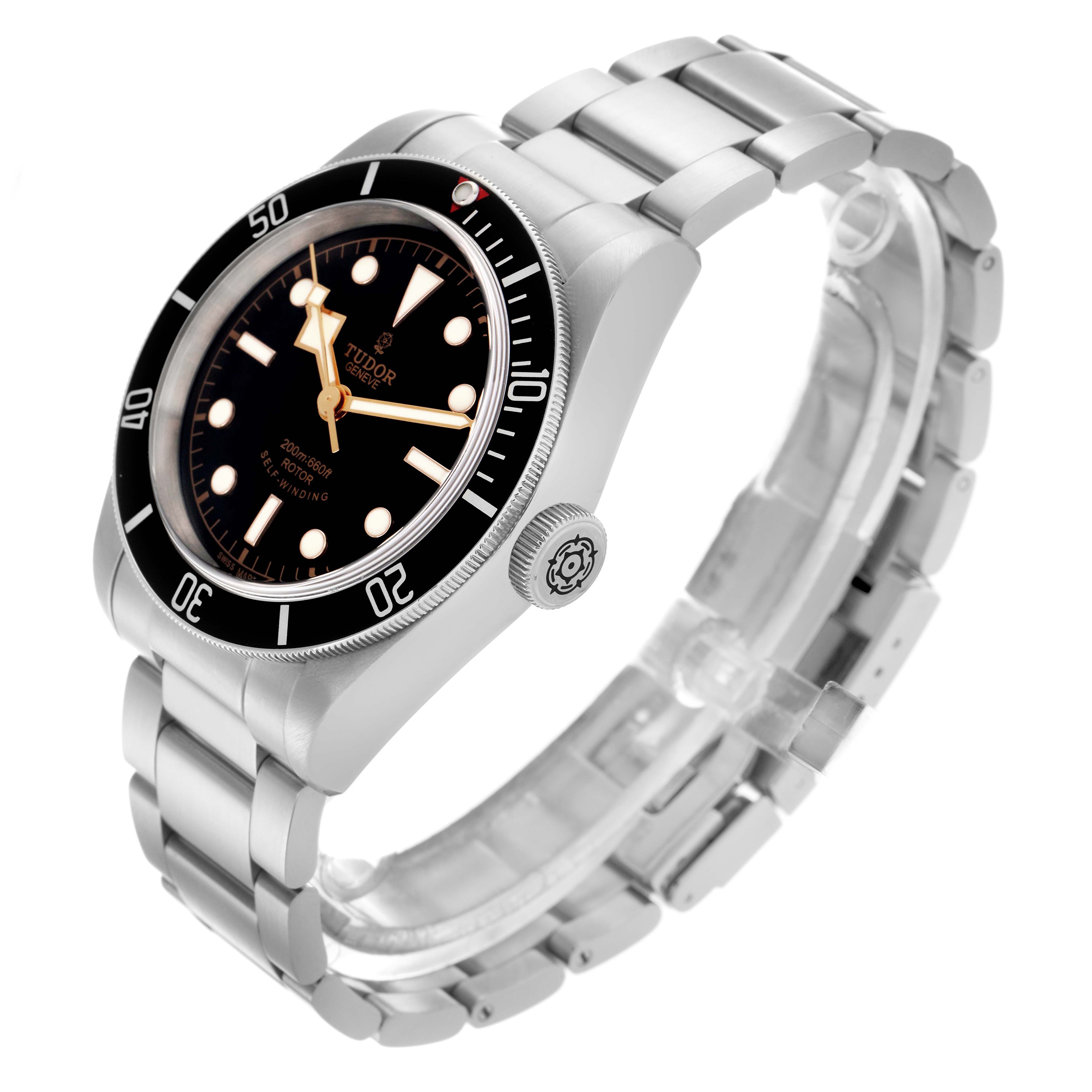 The Tudor Heritage Black Bay 79220N Men's Stainless Steel Black Dial 79220N Men's Stainless Steel Black Dial watch is shown at a three-quarter angle, highlighting the bezel, dial, crown, and metal bracelet.