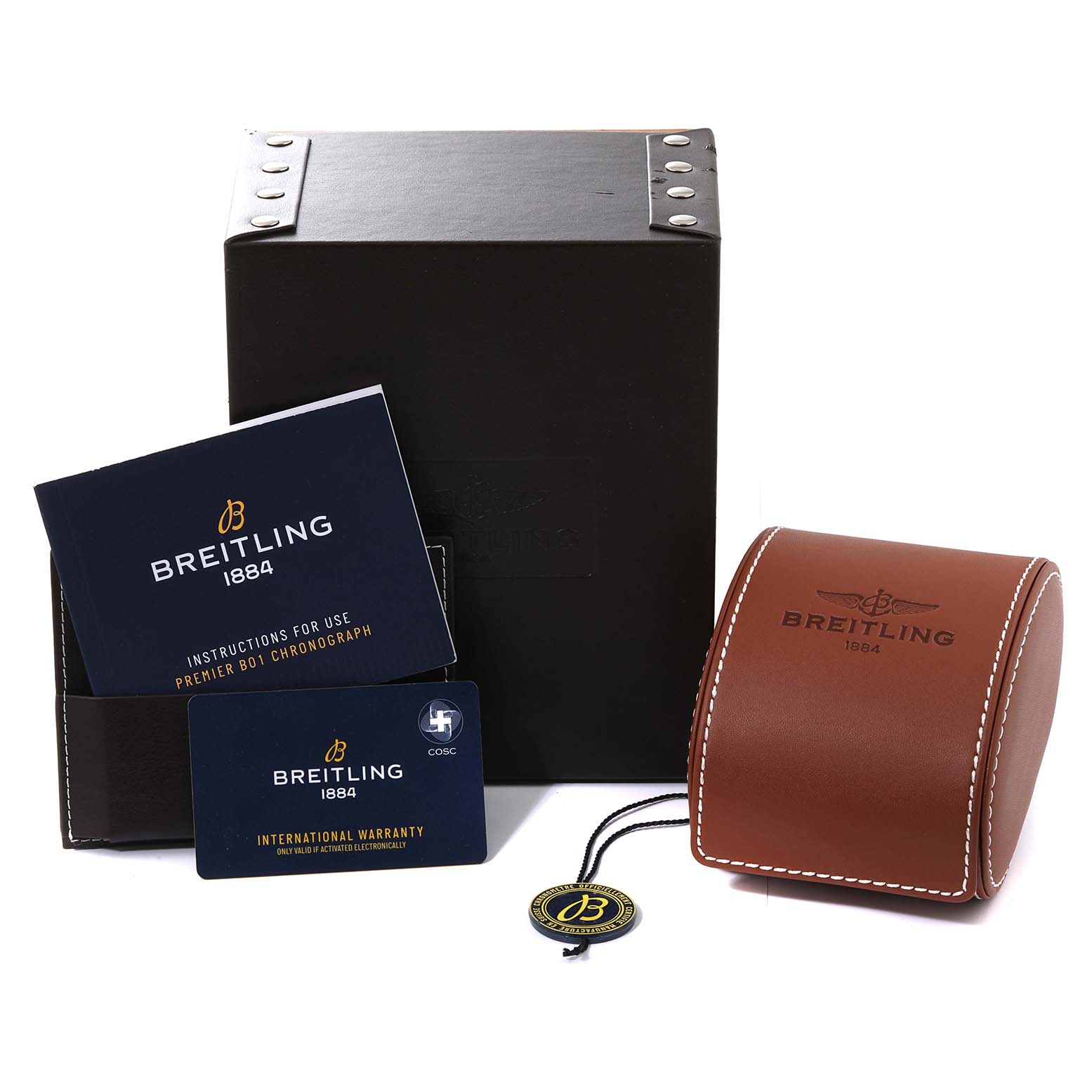 The image shows the packaging, instruction manual, warranty card, leather case, and tag for the Breitling Limited Series model.