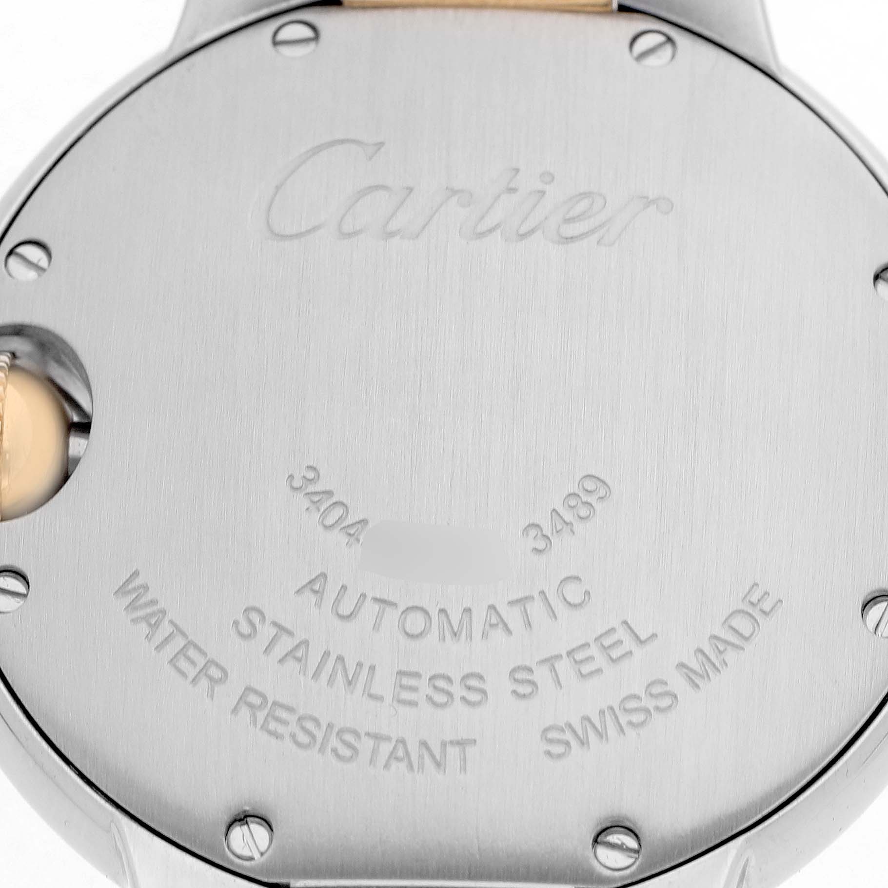 The image shows the back case of a Cartier Ballon Bleu W2BB0002 Women's Stainless Steel Silver Dial watch, highlighting the engravings and screws.
