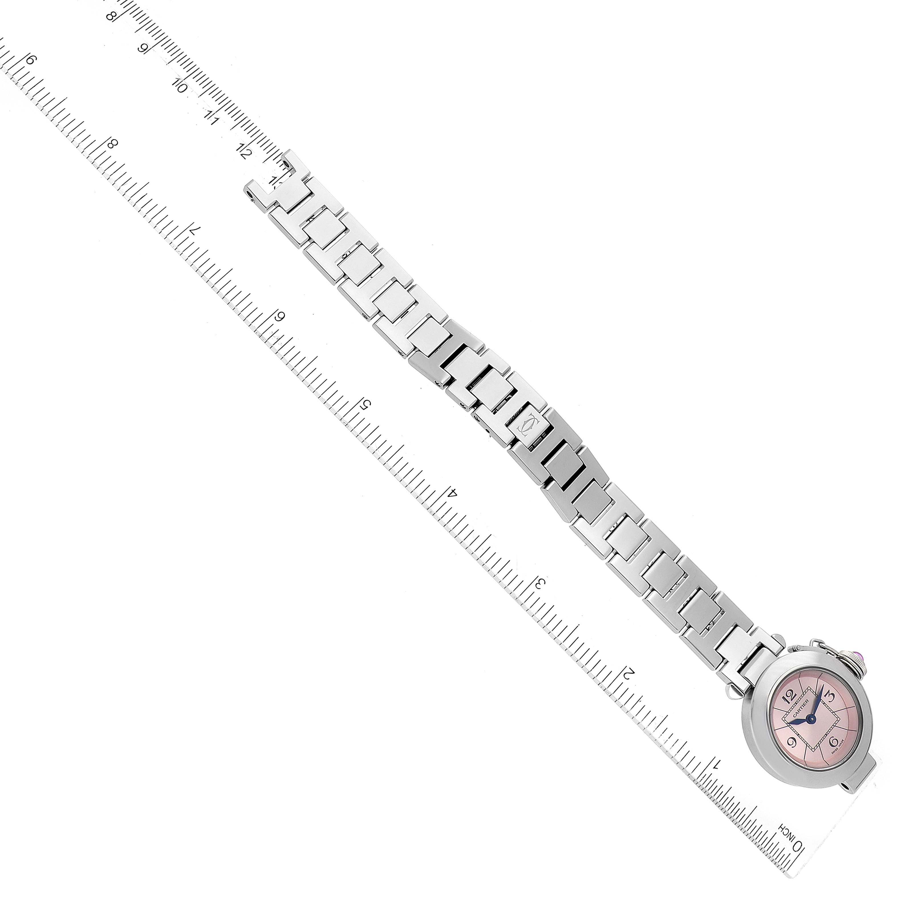 This image shows the Pasha model by Cartier laid flat with a ruler indicating its length.