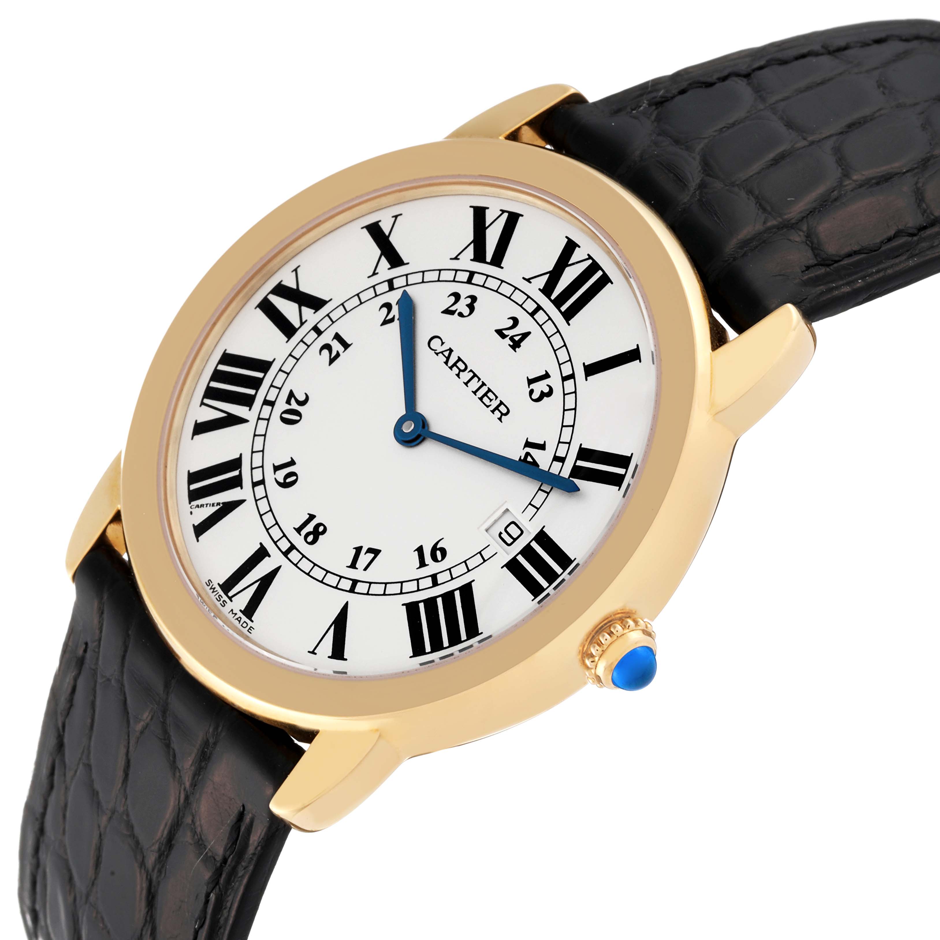 The image shows a Cartier Ronde W6700455 Men
s Yellow Gold Silver Dial W6700455 Men
s Yellow Gold Silver Dial watch at an angle, revealing its face, bezel, crown, and black leather strap.