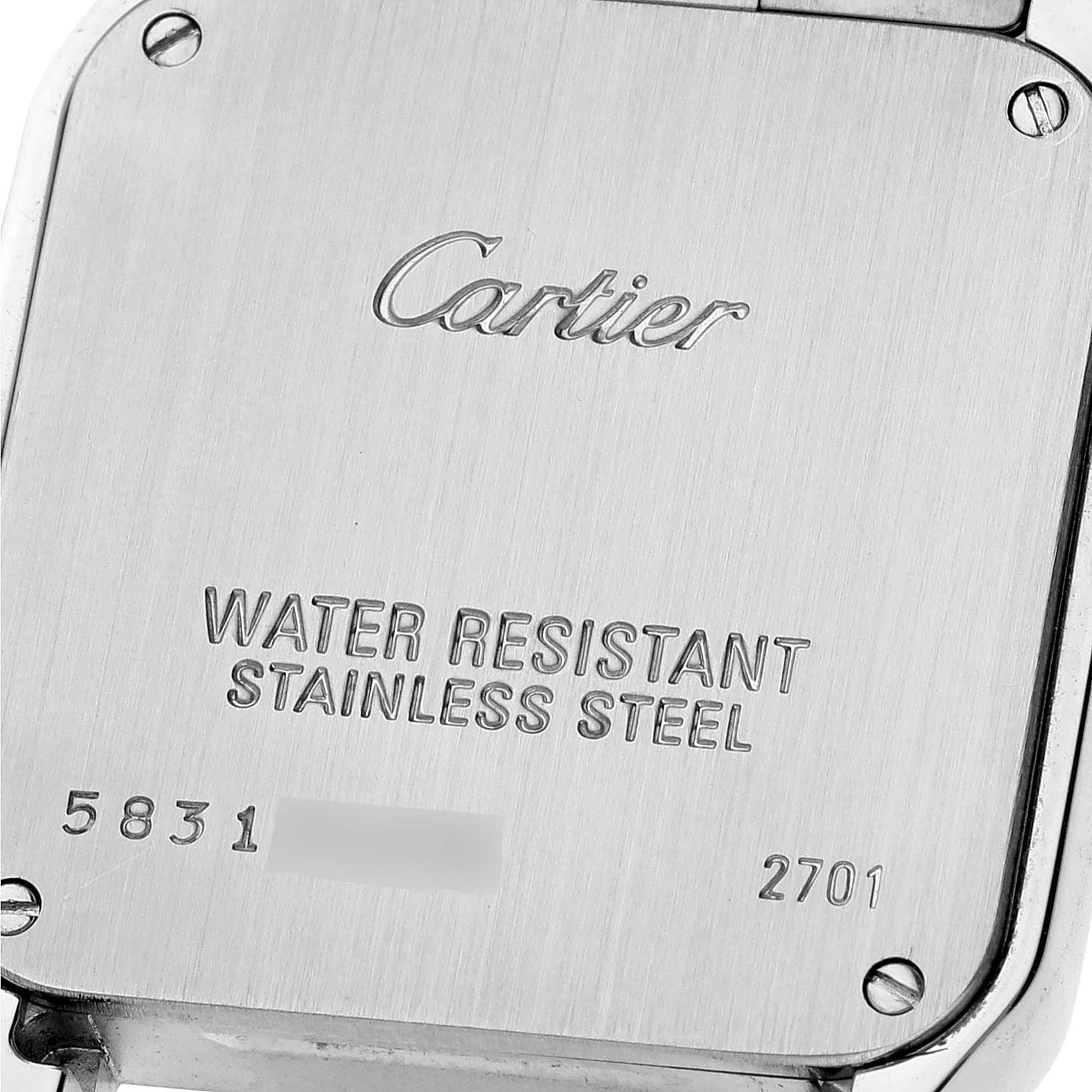 This is an angled close-up of the case back of the Santos Demoiselle model by Cartier, showing engravings and screws.