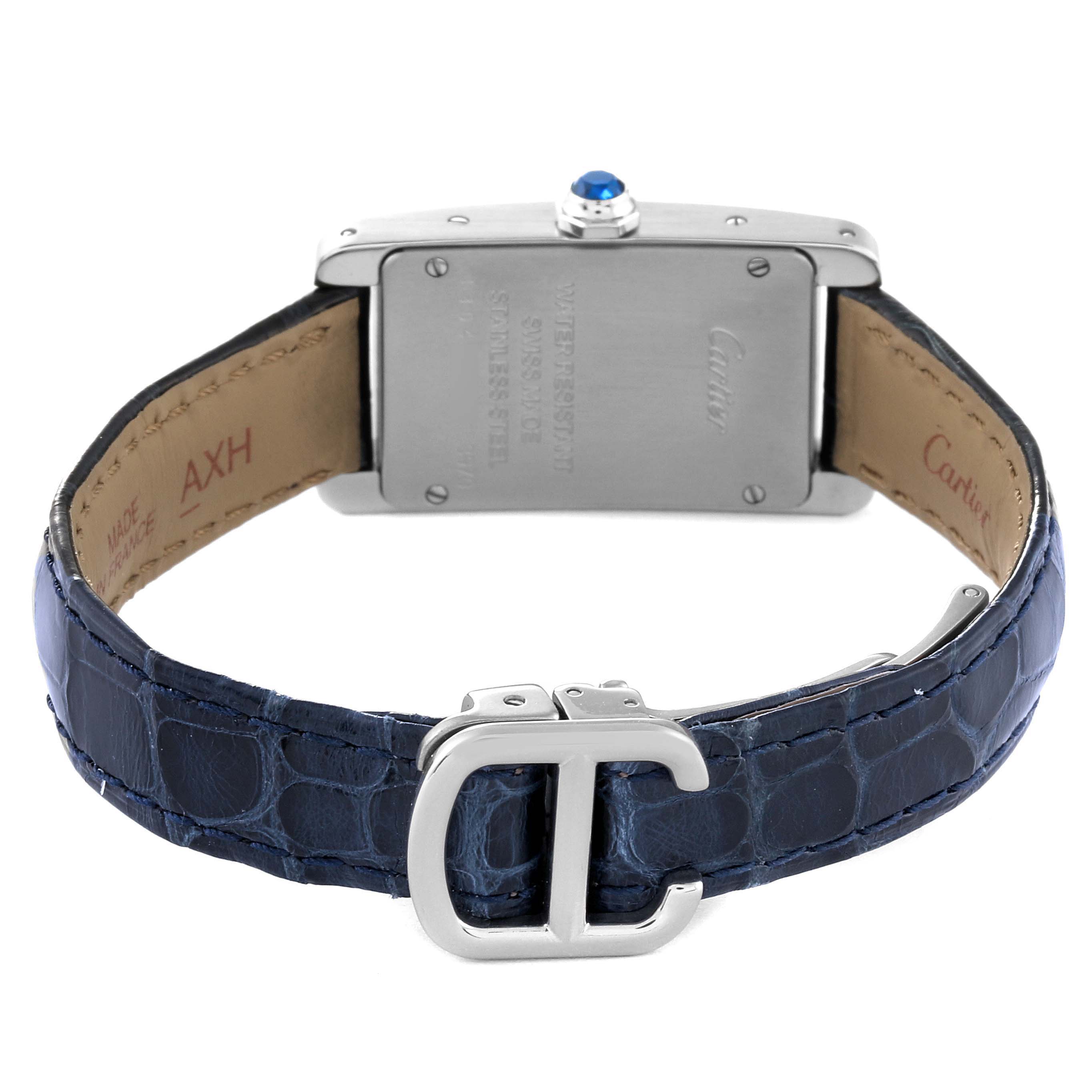 The image shows the back view of the Cartier Tank Americaine WSTA0016 Women's Stainless Steel Silver Dial WSTA0016 Women's Stainless Steel Silver Dial watch with a blue leather strap and T-shaped buckle.