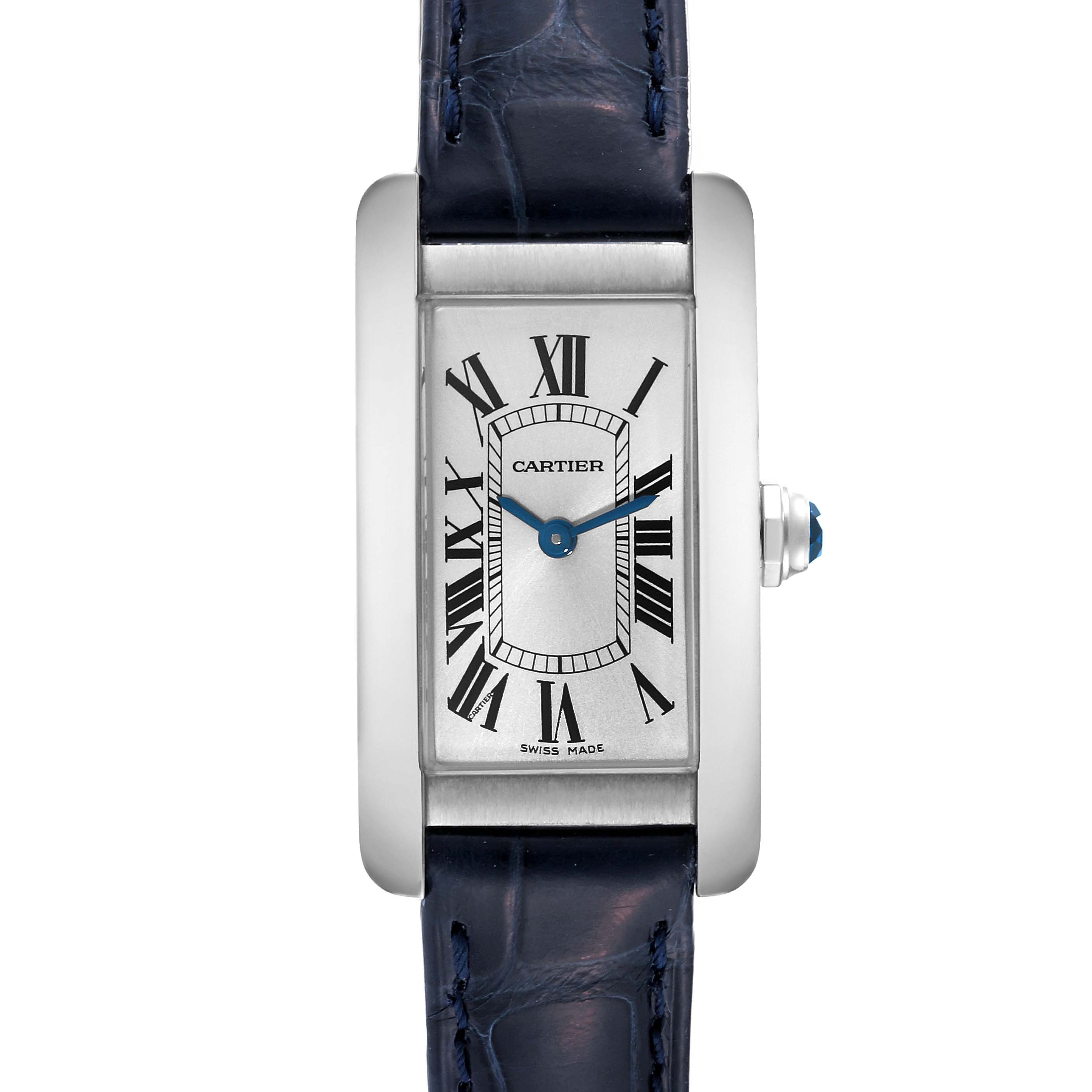 The image shows a frontal view of a Cartier Tank Americaine WSTA0016 Women's Stainless Steel Silver Dial WSTA0016 Women's Stainless Steel Silver Dial watch, highlighting its rectangular face, Roman numerals, and blue leather strap.