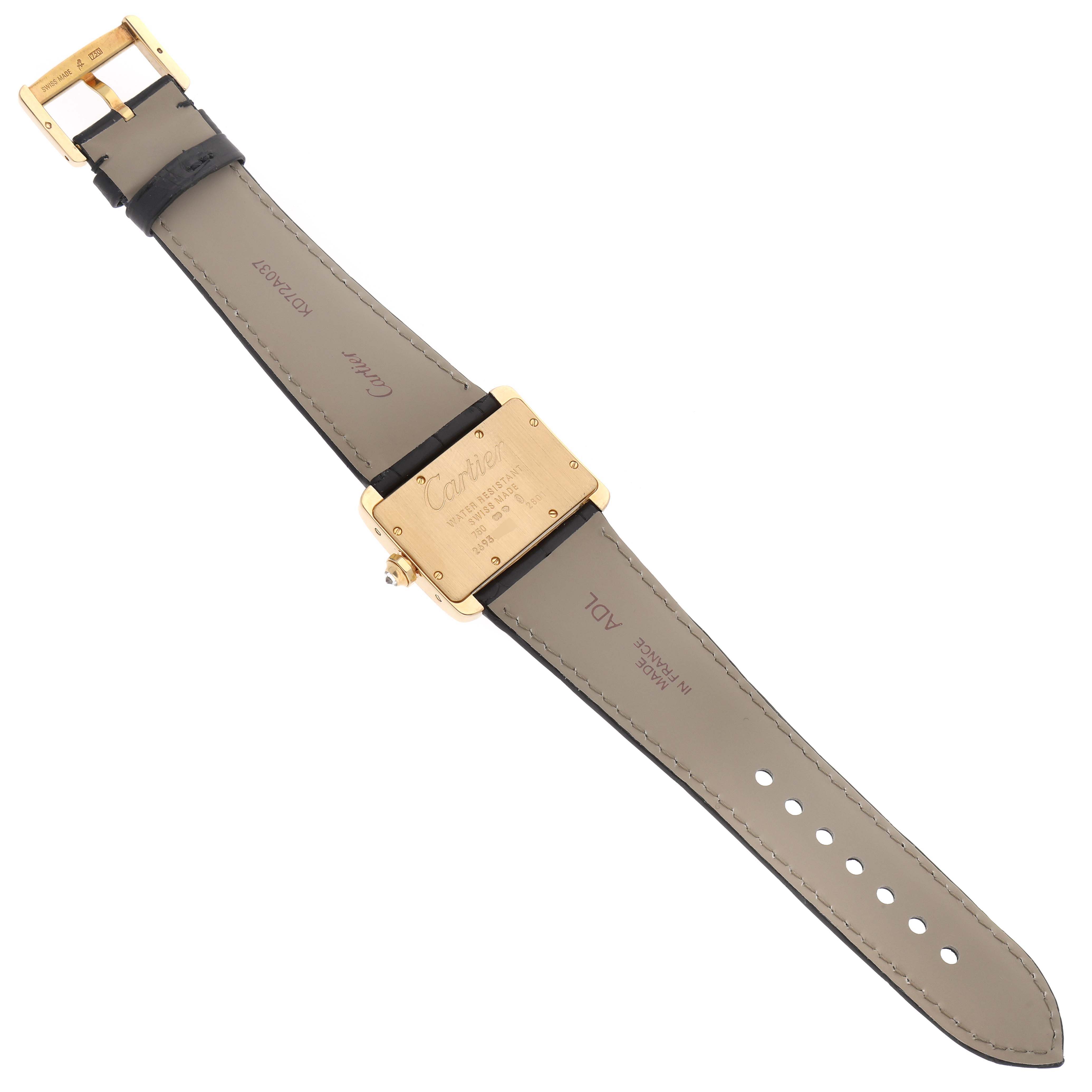 The image shows the back view of a Tank Divan watch by Cartier, displaying the strap, buckle, and case back.