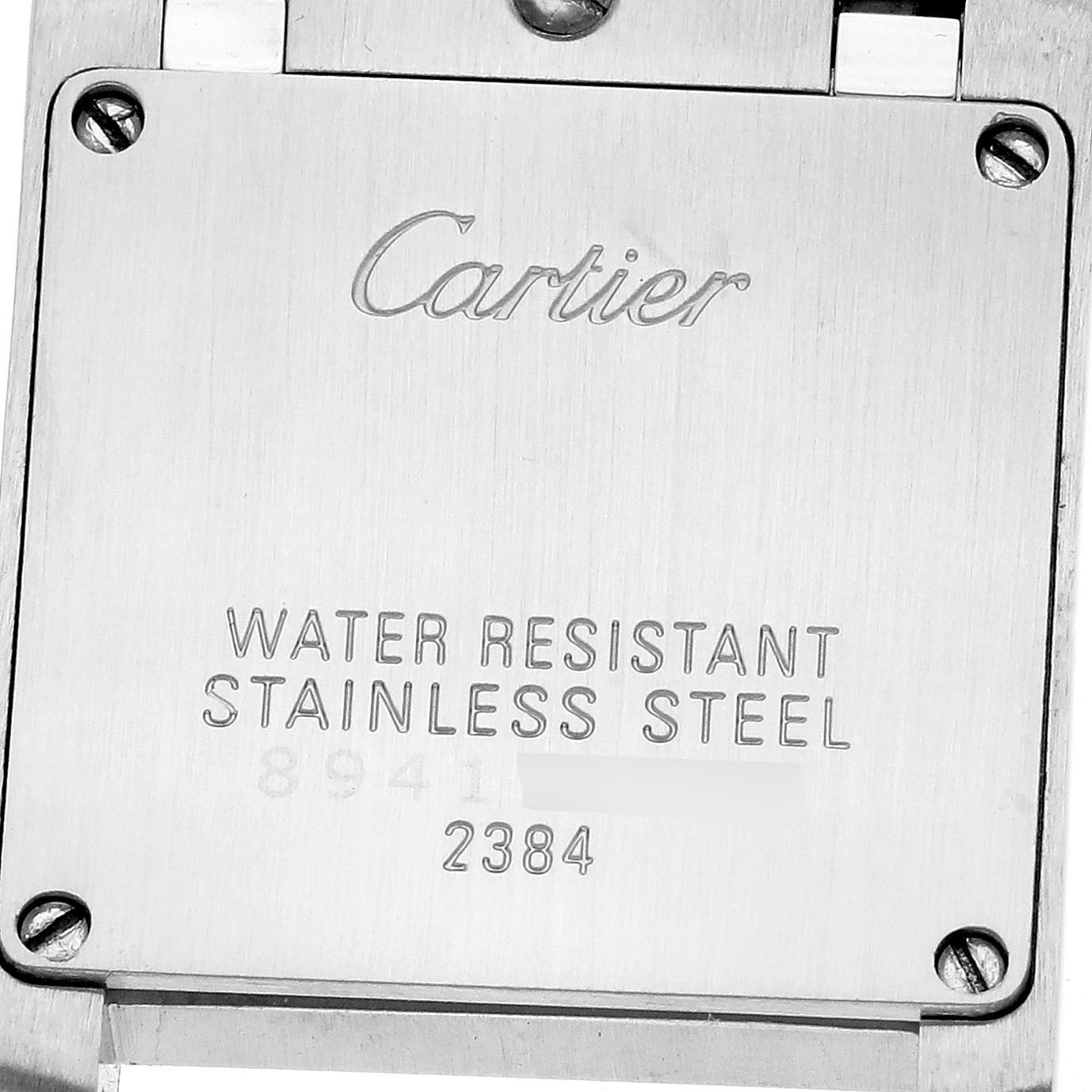 The image shows the back case of a Cartier Tank Francaise W51034Q3 Women's Stainless Steel Mother of Pearl Dial W51034Q3 Women's Stainless Steel Mother of Pearl Dial watch, highlighting engraving details and screws.