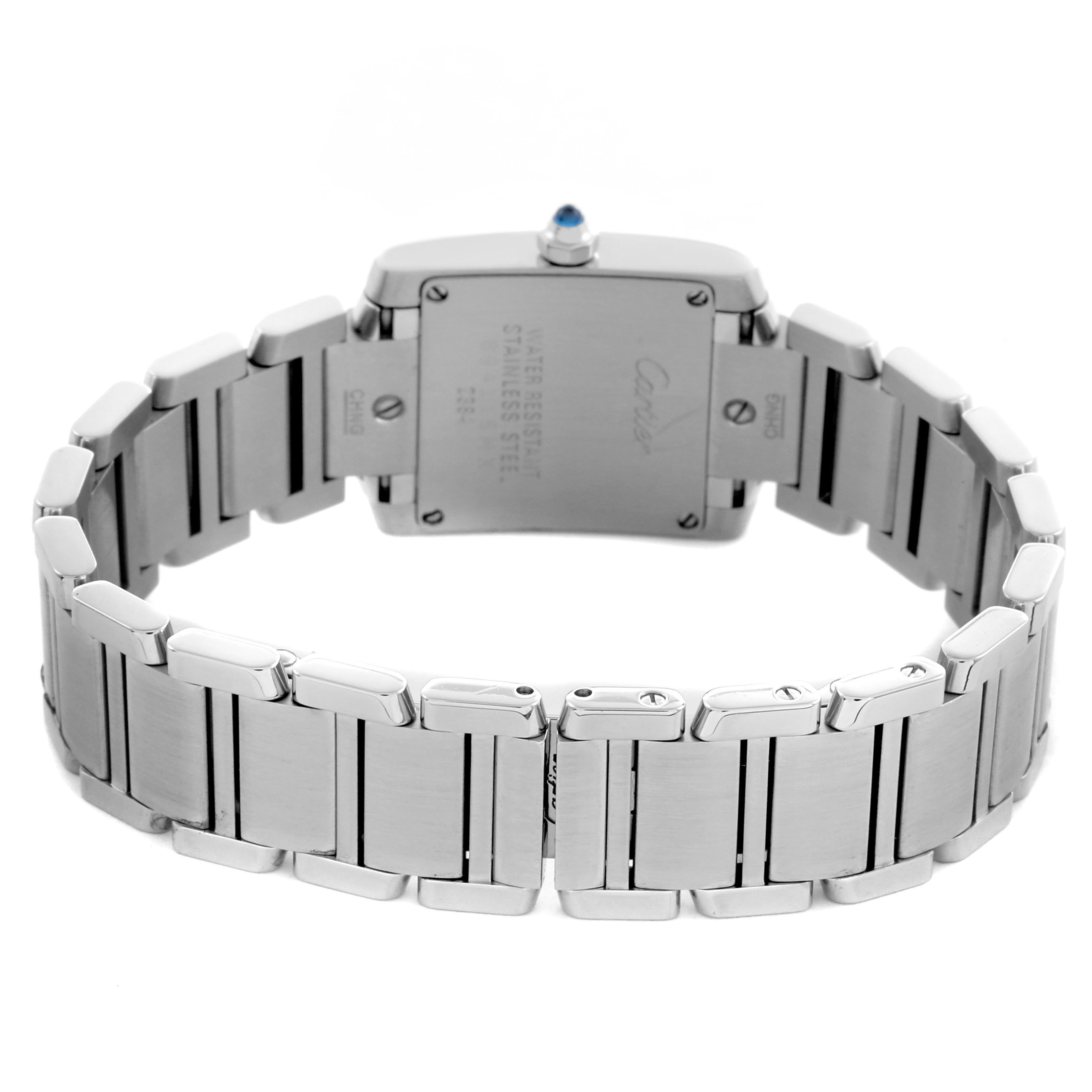 The image shows the back of a Cartier Tank Française watch, highlighting the stainless steel bracelet and case back.