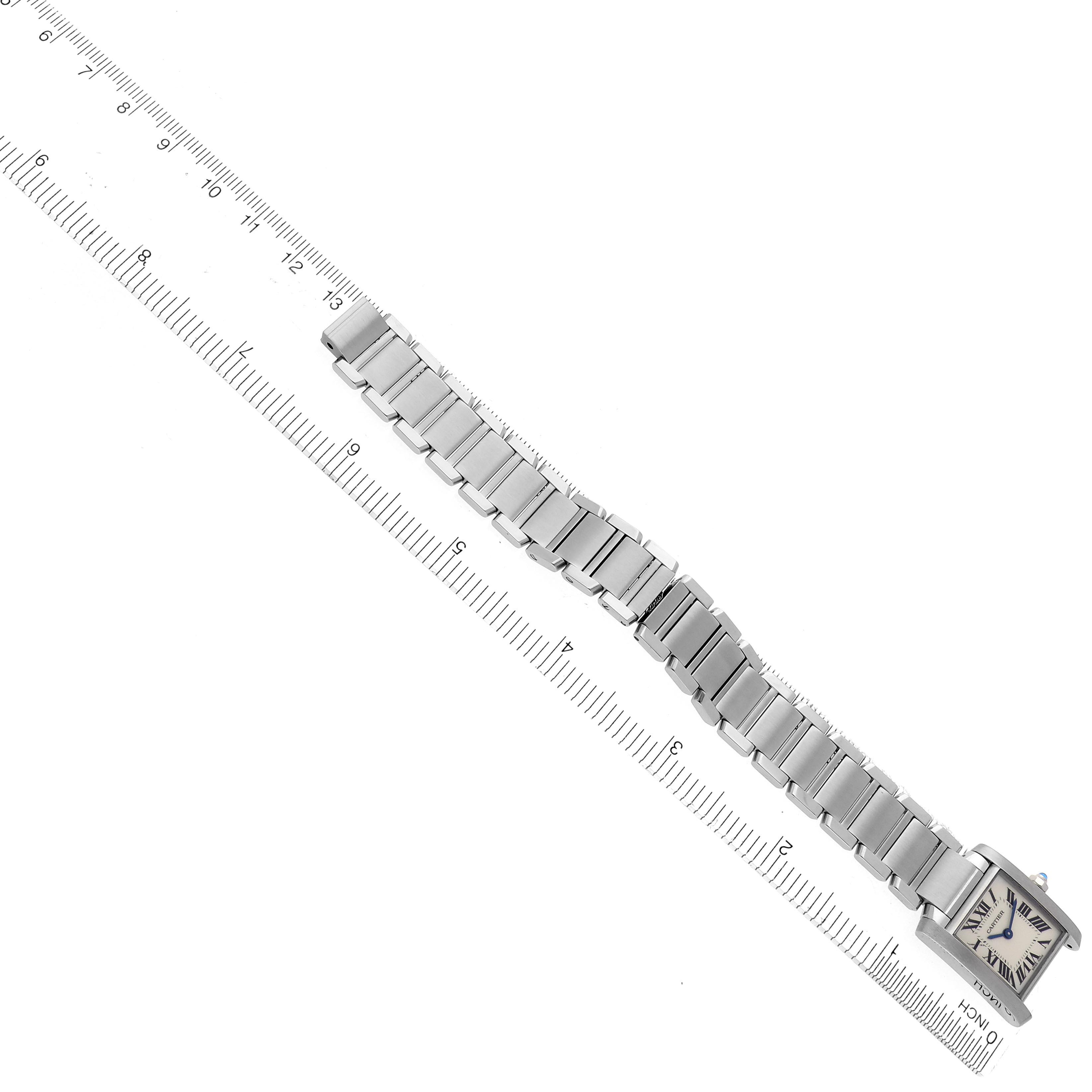 The Cartier Tank Francaise W51008Q3 Women's Stainless Steel Silver Dial W51008Q3 Women's Stainless Steel Silver Dial watch is shown from a top-down angle, with its full metal bracelet and face visible alongside a ruler.