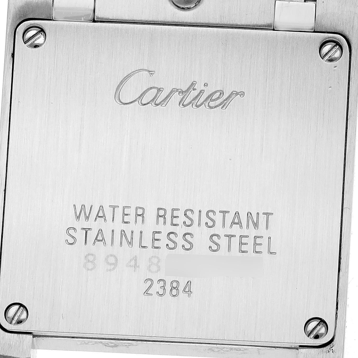 The image shows the back case of a Cartier Tank Française watch, displaying "water-resistant" and "stainless steel" engravings.