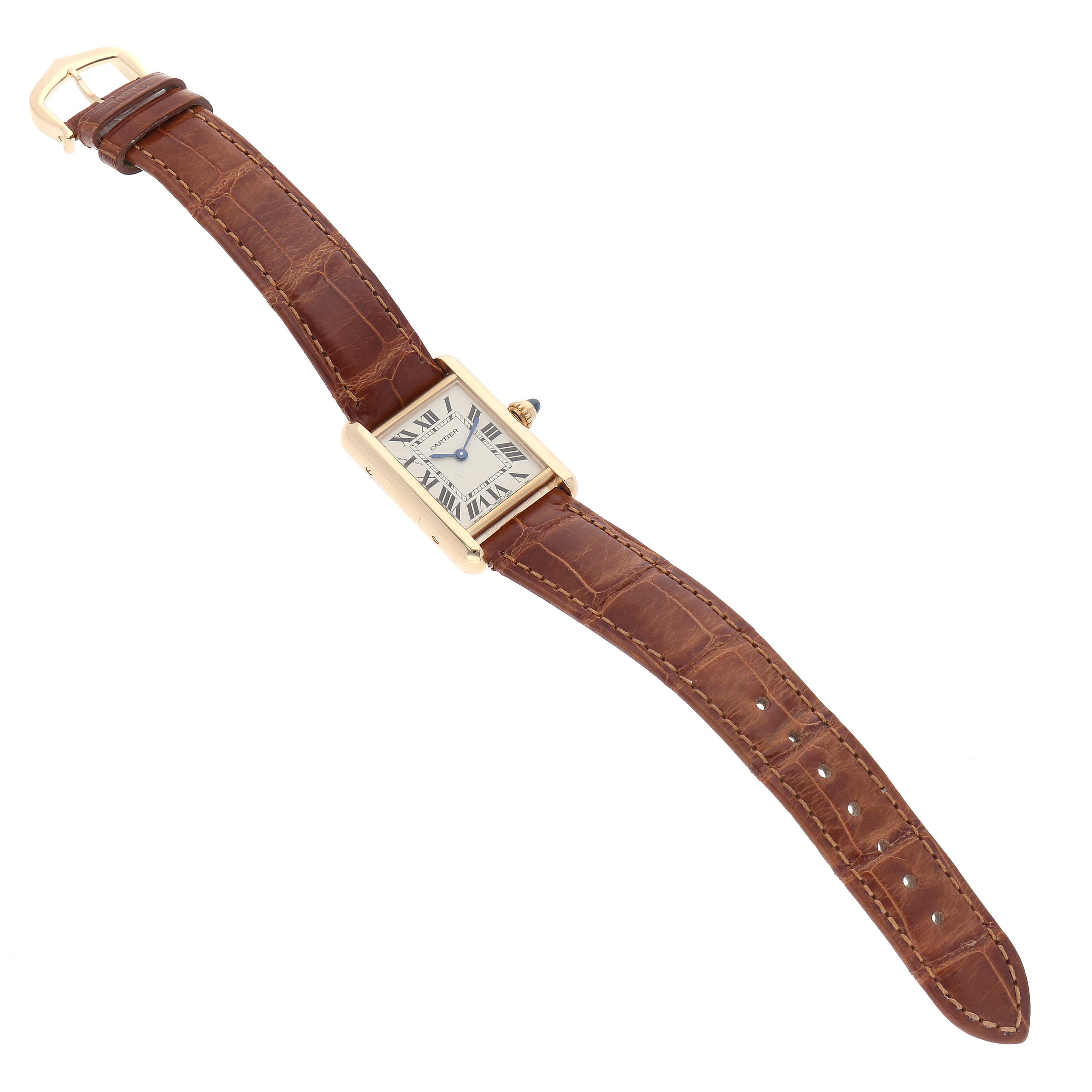 The image shows a Tank Louis Cartier watch at a slight angle, with a full view of its face and brown leather strap.
