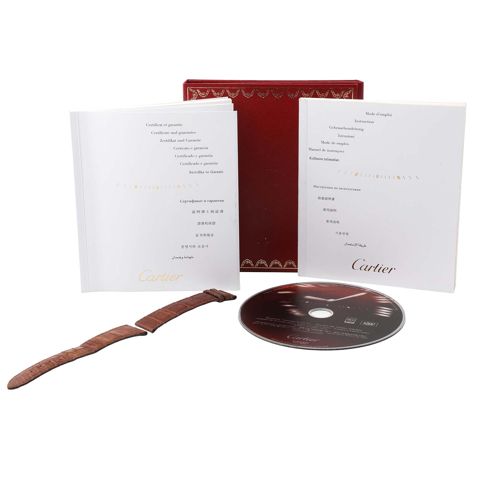 The image displays Cartier Tank Louis W1529756 Men's Yellow Gold Silver Dial accessories, including a brown strap, two booklets, a CD, and a red box.