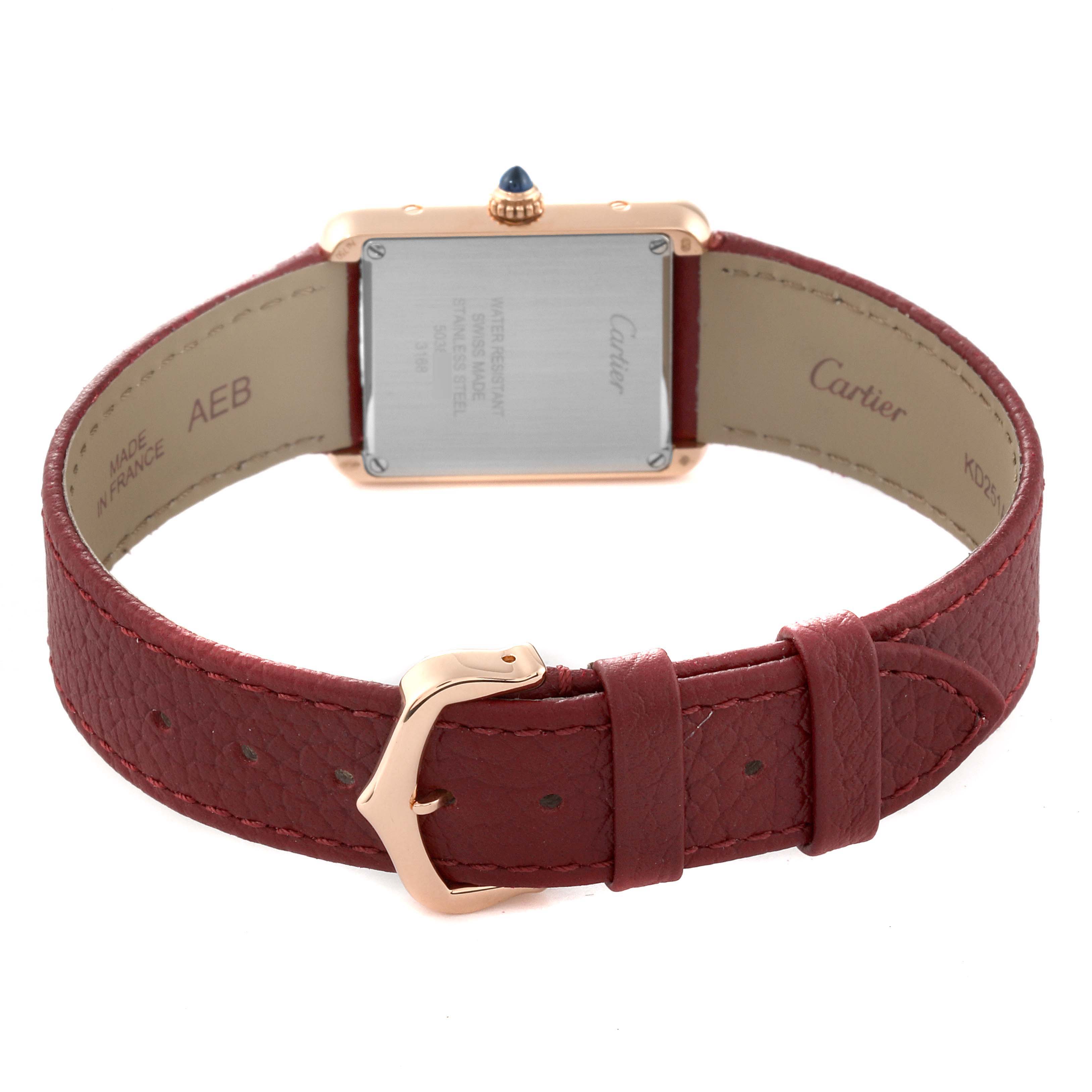 This image shows the back of the Cartier Tank Solo W5200024 Women's Steel and Gold (two tone) Silver Dial W5200024 Women's Steel and Gold (two tone) Silver Dial watch and its red leather strap with a gold buckle clasp.