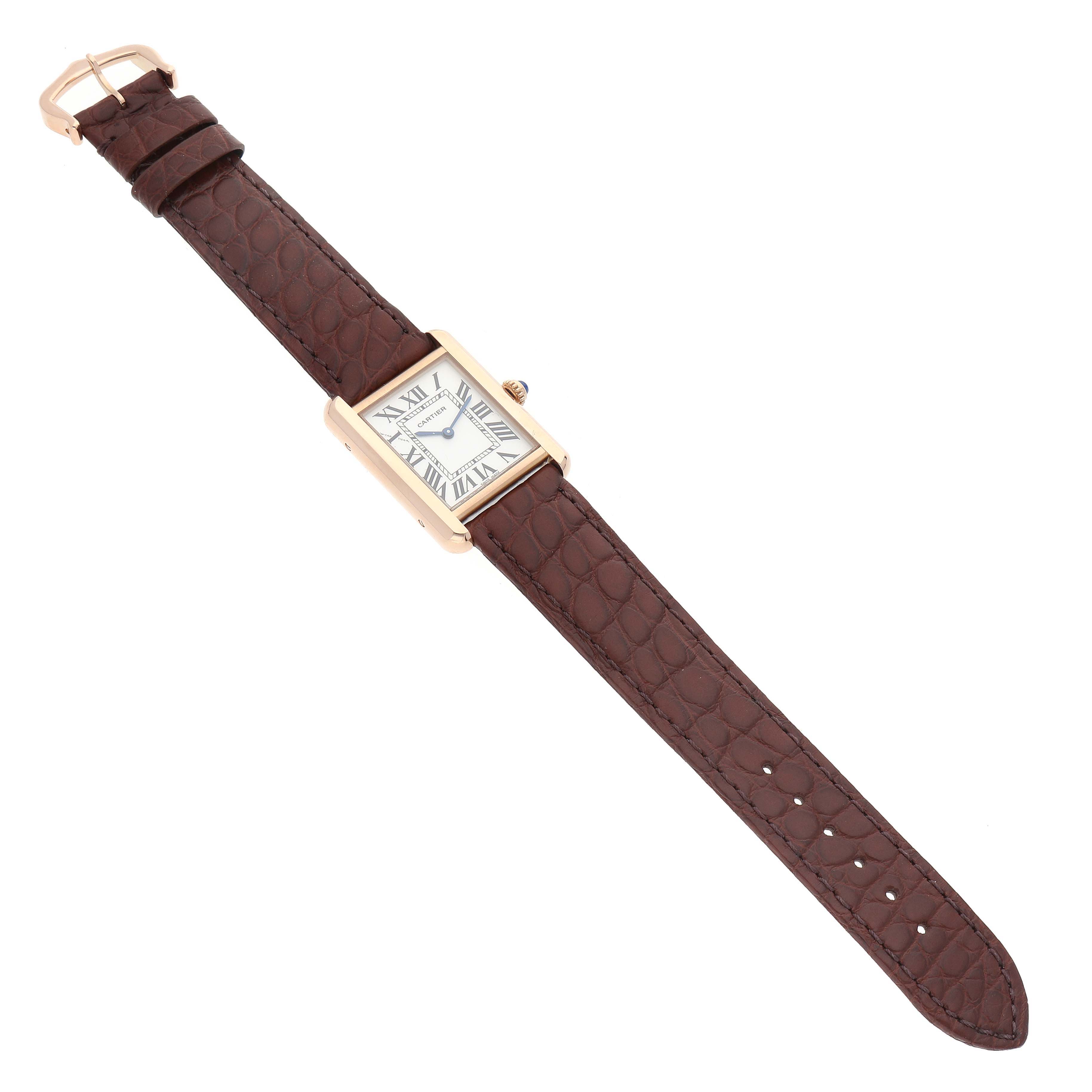 The image shows a Cartier Tank Solo W5200024 Women
s Steel and Gold (two tone) Silver Dial W5200024 Women
s Steel and Gold (two tone) Silver Dial watch from a top view, highlighting its brown leather strap and rectangular face.