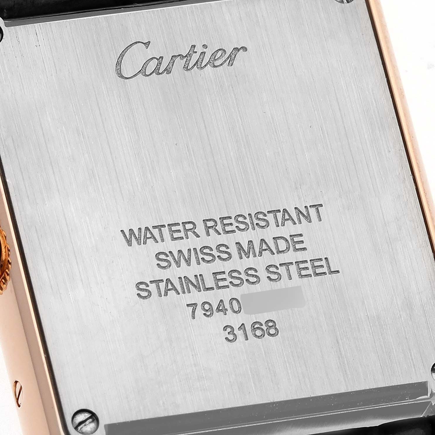 The image shows the engraved back case of a Cartier Tank Solo W5200024 Women
s Steel and Gold (two tone) Silver Dial W5200024 Women
s Steel and Gold (two tone) Silver Dial watch, detailing its water resistance and stainless steel composition.