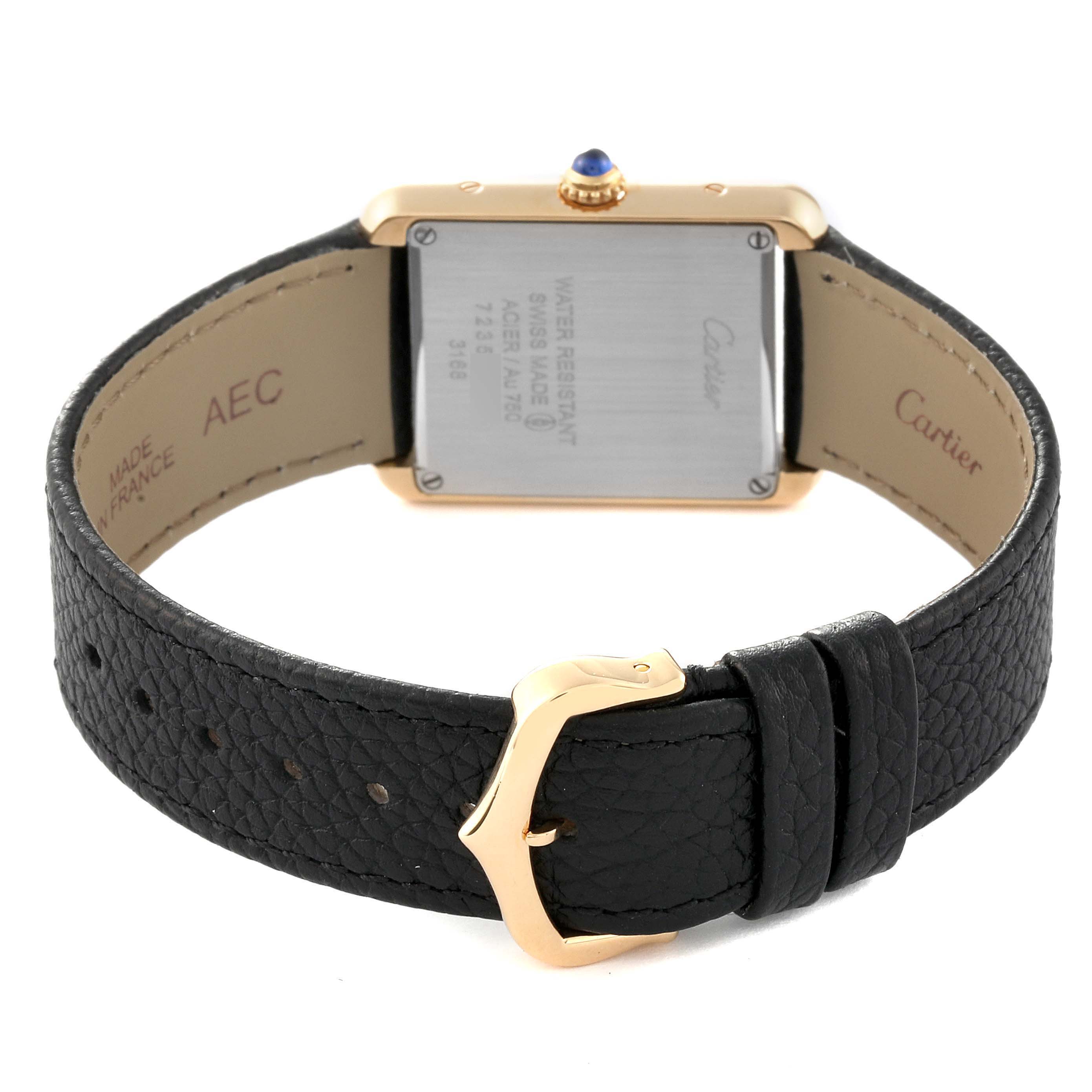 The image shows the back view of a Cartier Tank Solo W5200002 Women
s Steel and Gold (two tone) Silver Dial W5200002 Women
s Steel and Gold (two tone) Silver Dial watch, highlighting the caseback, black leather strap, and gold buckle.