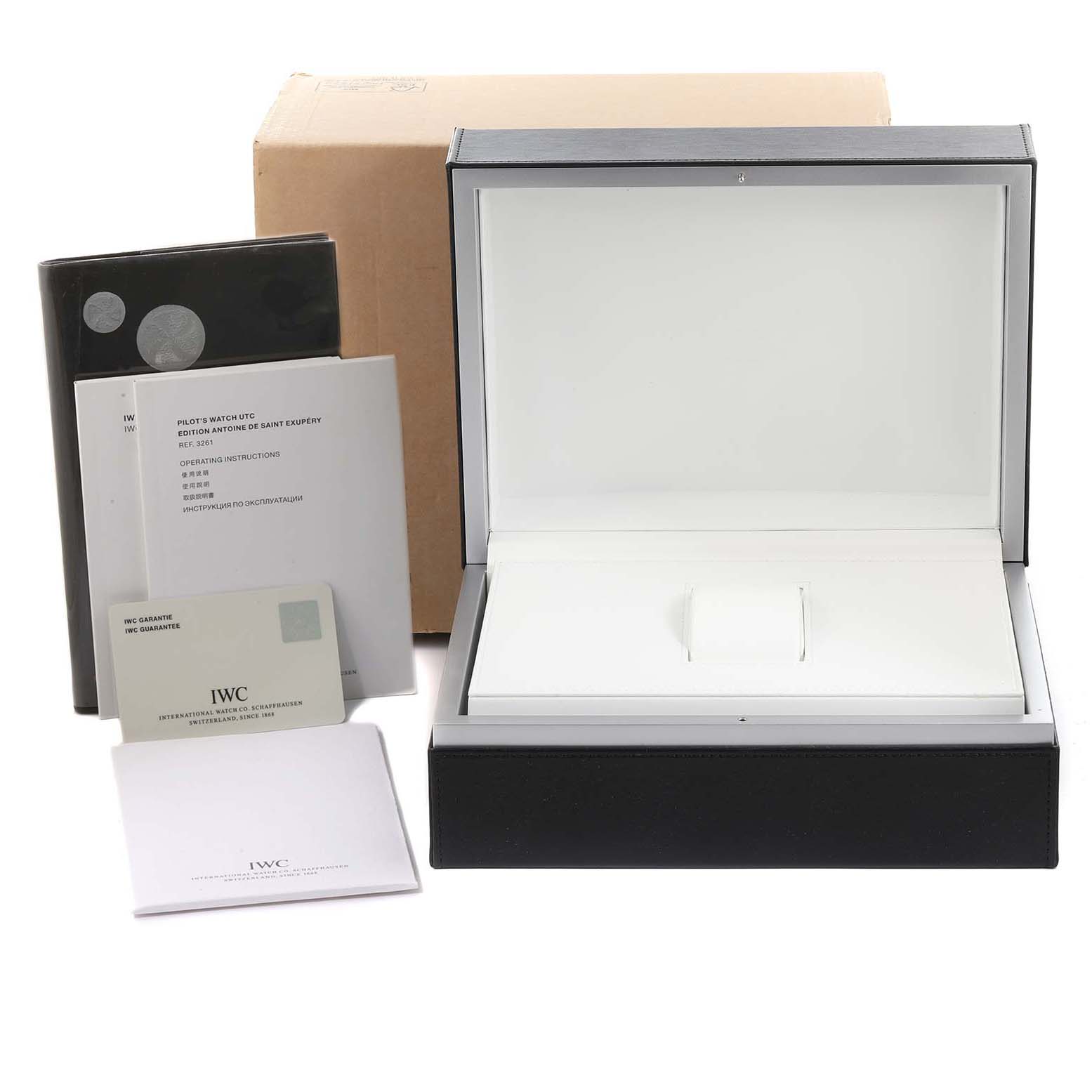 The image shows the packaging and documentation for an IWC Pilot IW326104 Men's Stainless Steel Brown Dial IW326104 Men's Stainless Steel Brown Dial model, including the watch box and booklets.