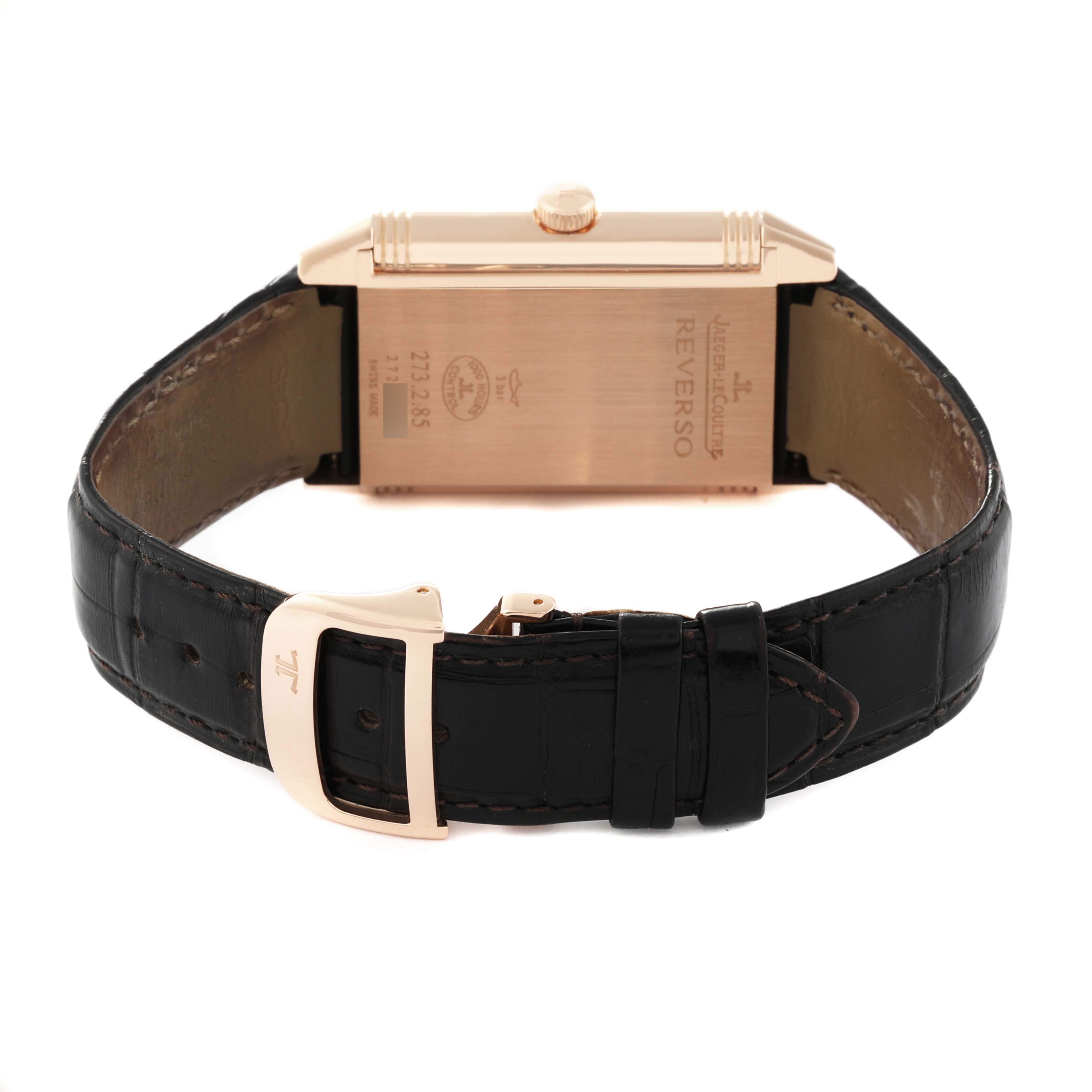 The image shows the backside of a Jaeger-LeCoultre Reverso watch, highlighting the clasp and leather strap.