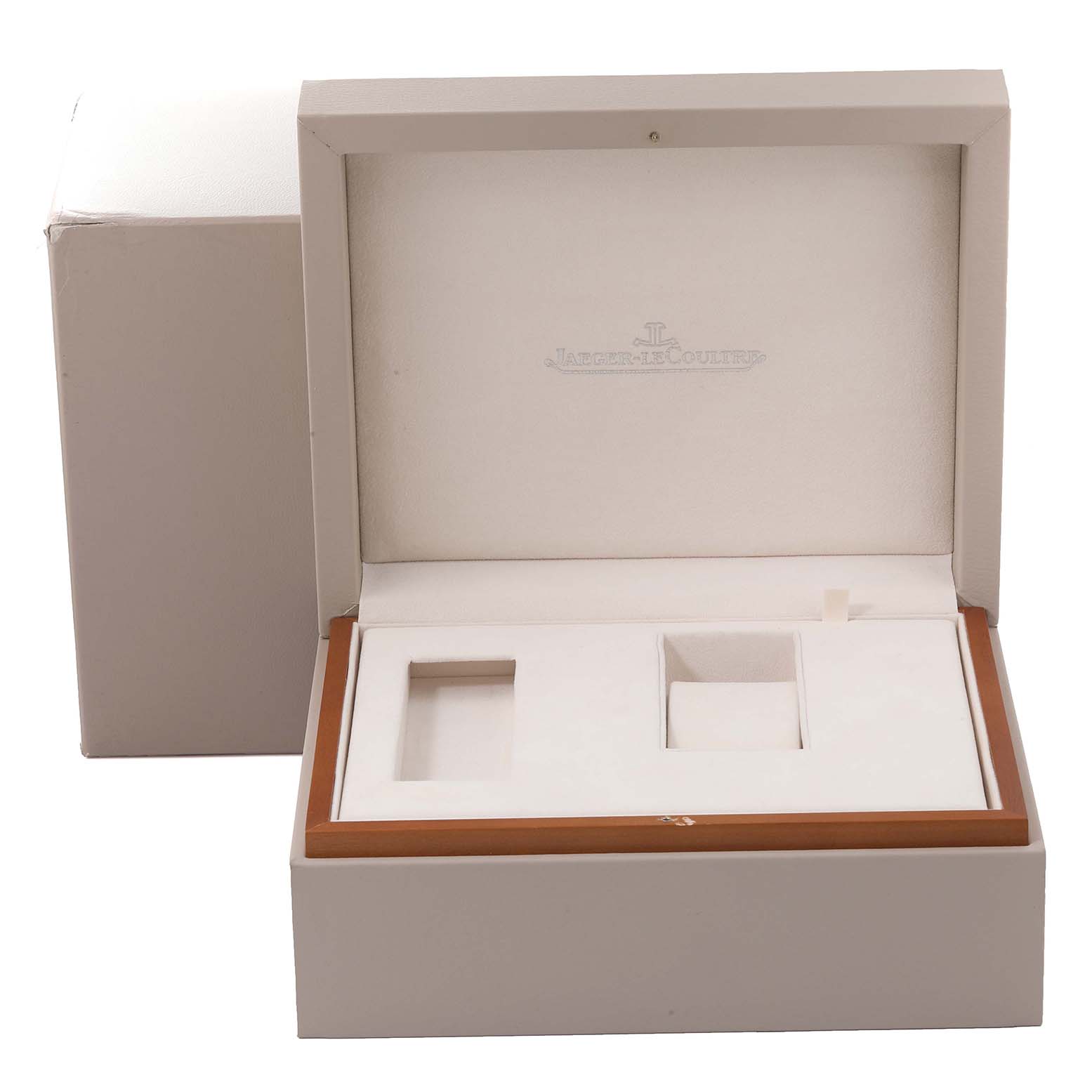 The image shows the open packaging box for the Reverso model by Jaeger LeCoultre, including compartments for the watch and accessories.