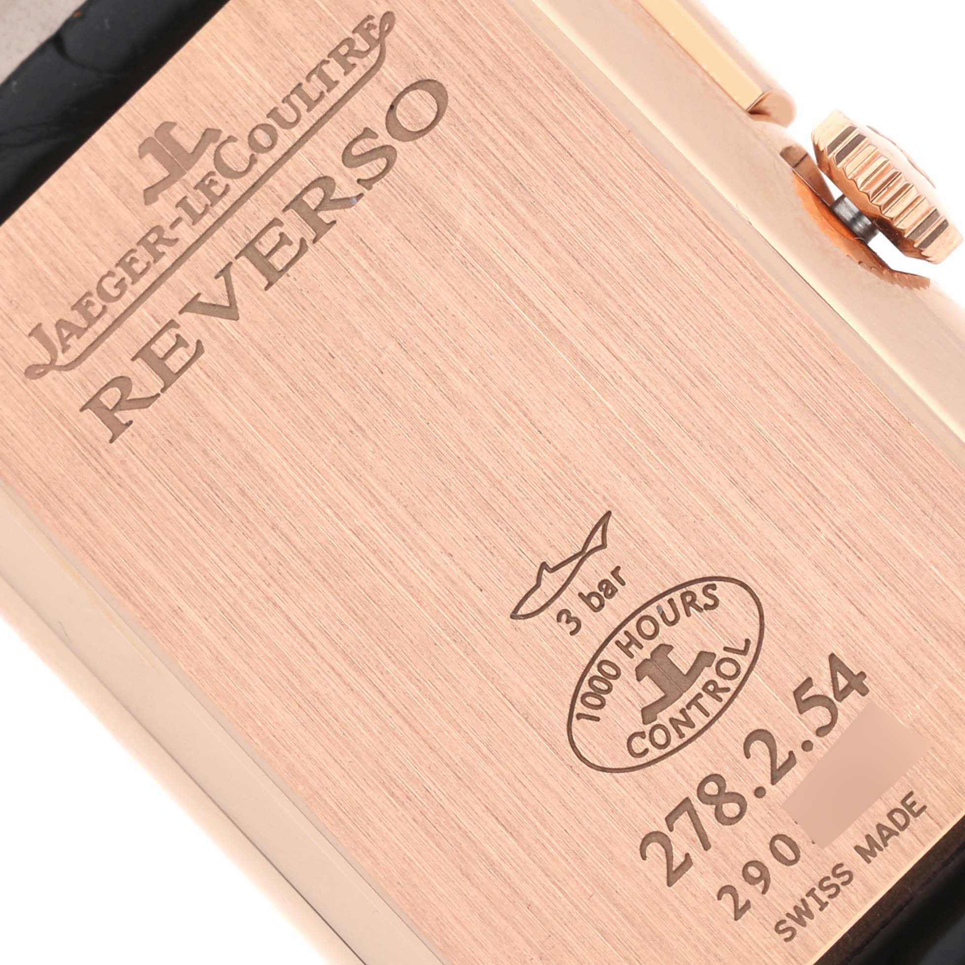The image shows the case back of a Jaeger-LeCoultre Reverso watch, highlighting engraved details and the crown.