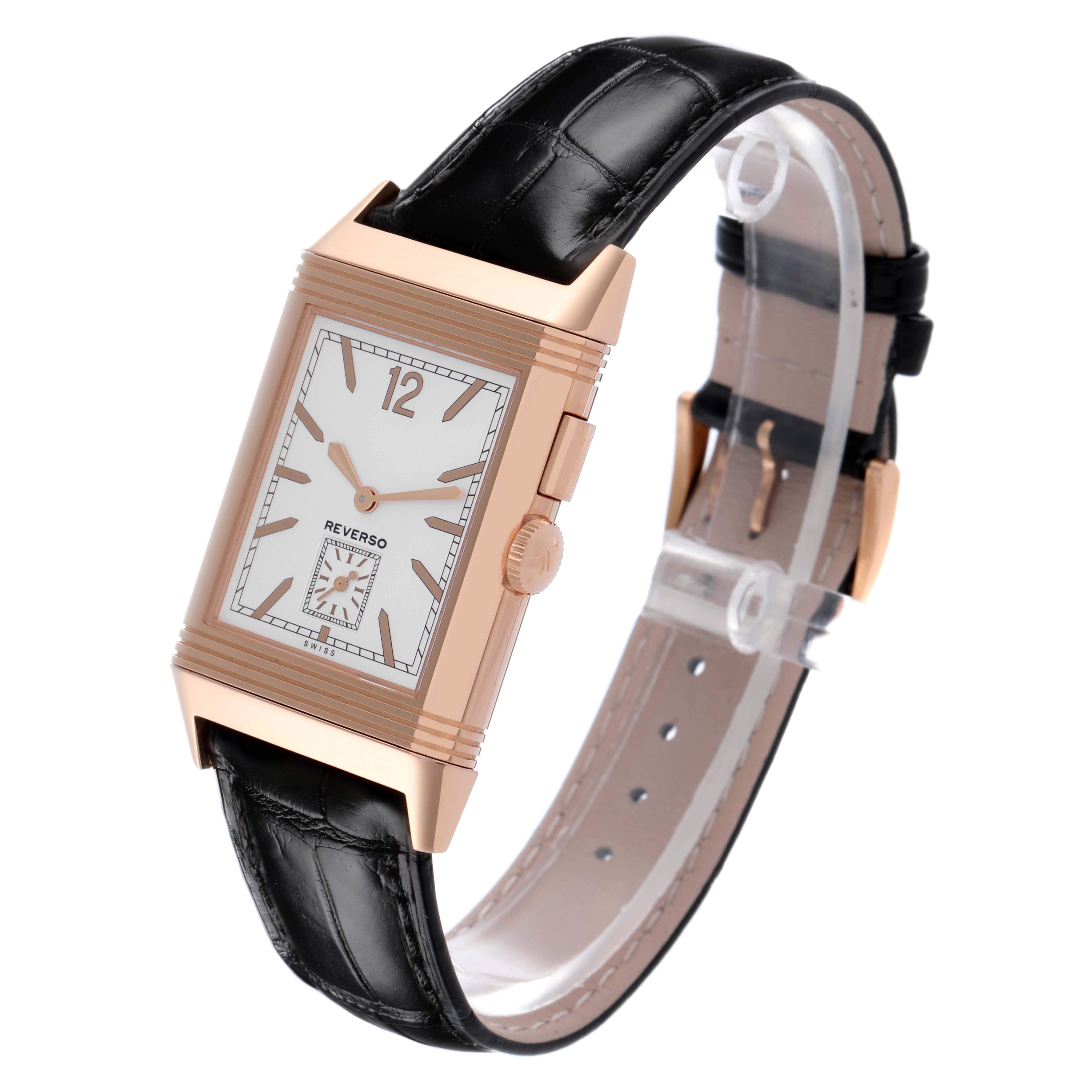 The Jaeger-LeCoultre Reverso watch is shown at a three-quarter angle, highlighting the rectangular face, crown, and black leather strap.