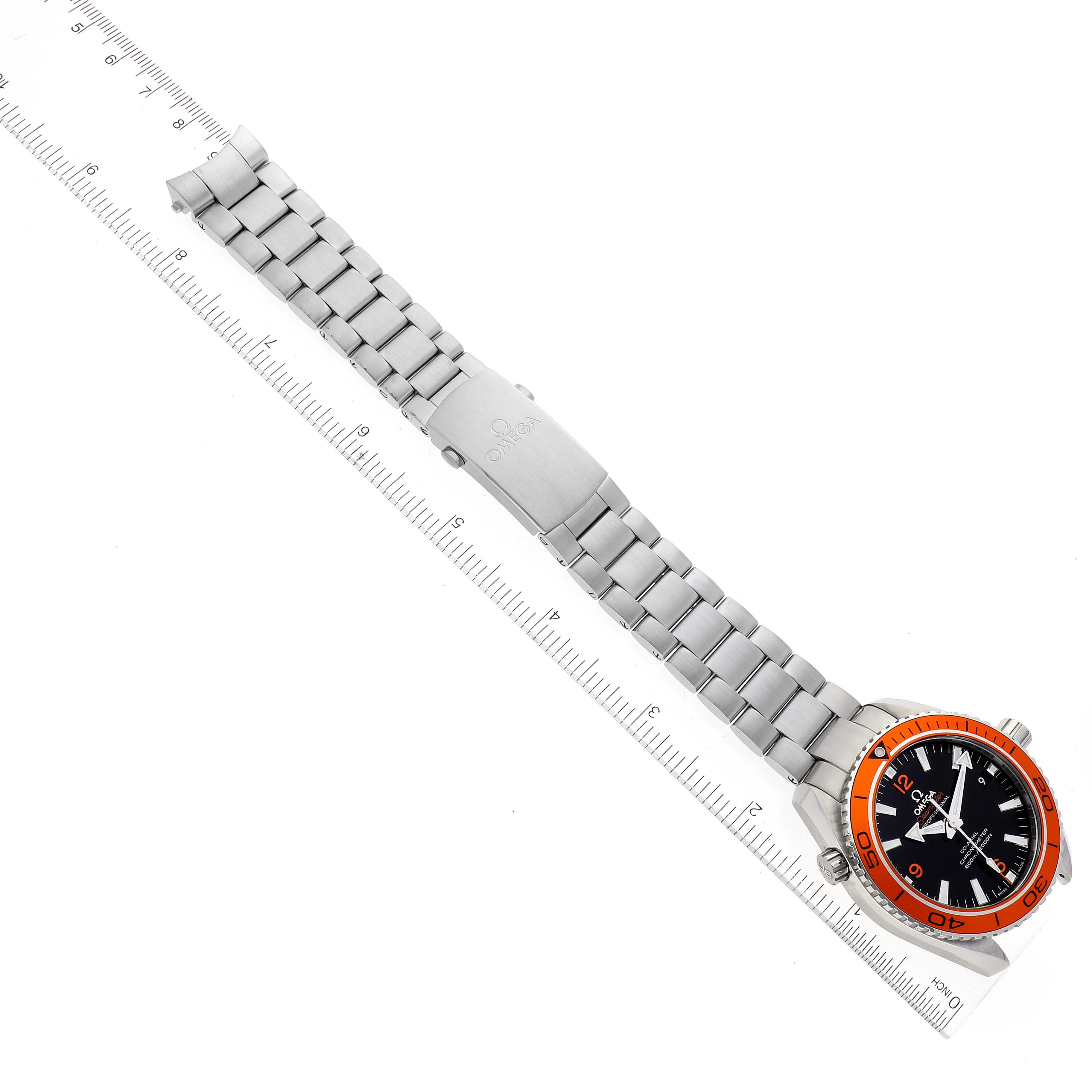 The Omega Seamaster watch is shown from the top, displaying its bracelet, clasp, and dial with an orange bezel.