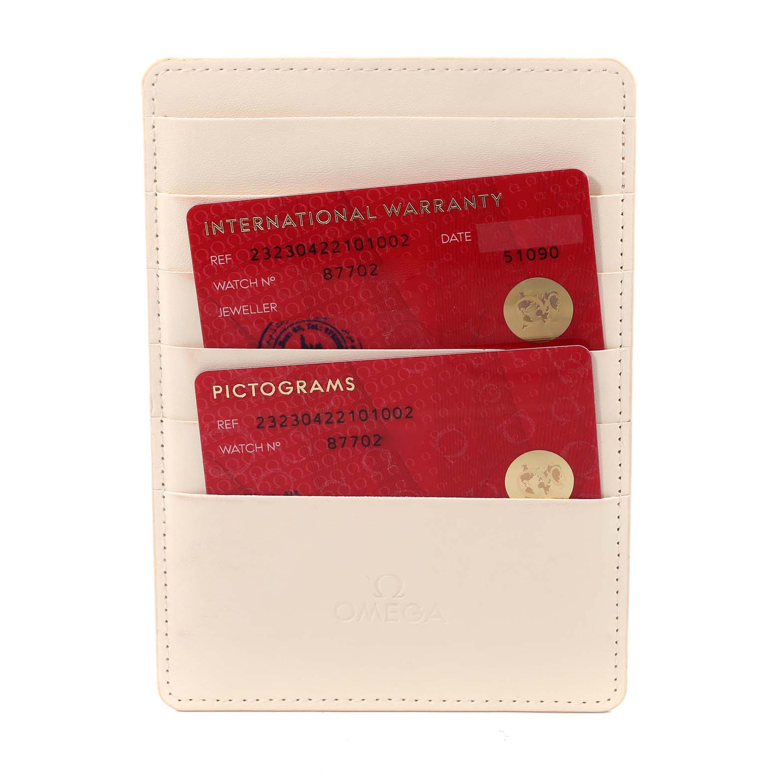 The image shows Omega Seamaster model warranty and pictograms cards in a white cardholder, front view.