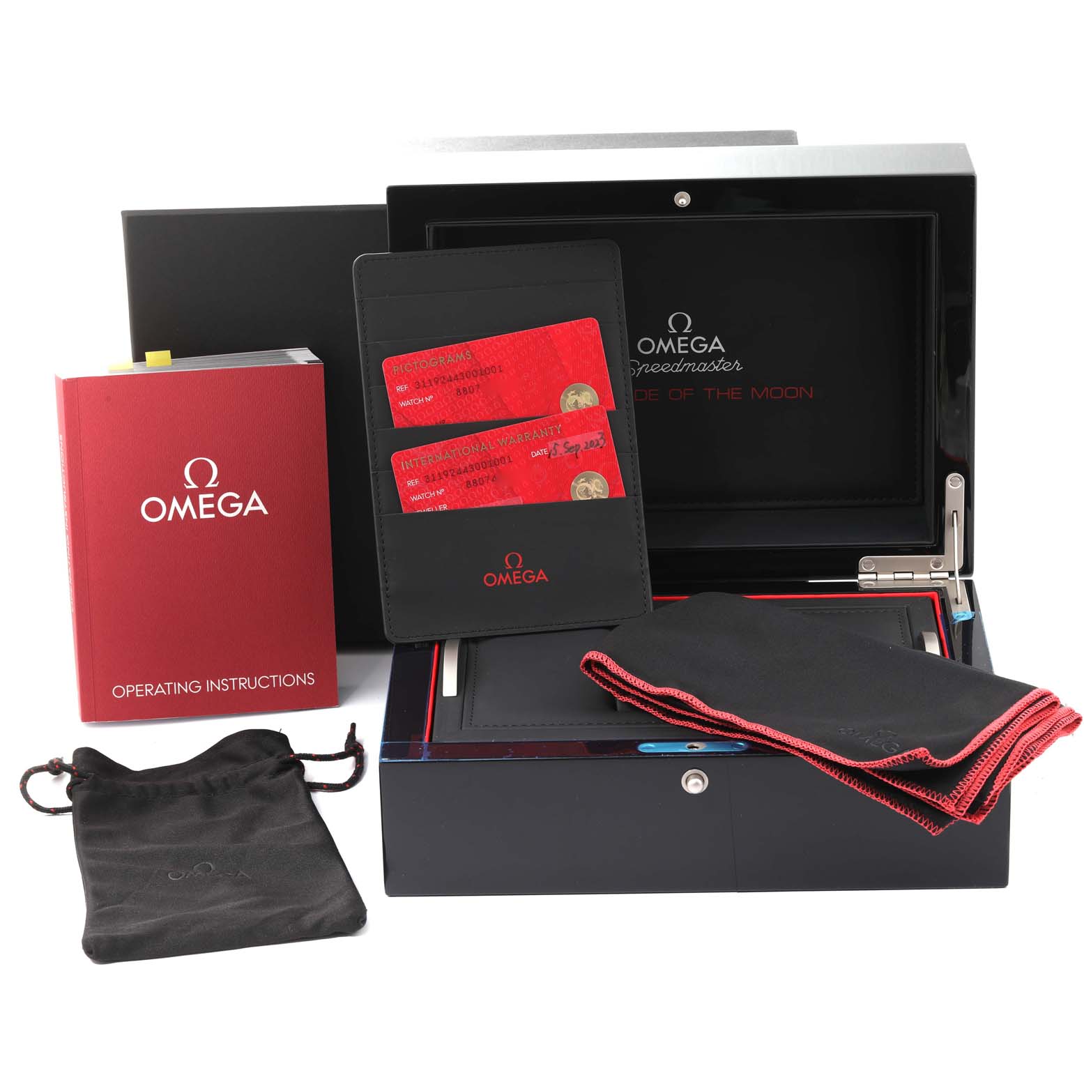 The image shows the Omega Speedmaster 311.92.44.30.01.001 Men's Ceramic Black Dial 311.92.44.30.01.001 Men's Ceramic Black Dial's presentation box, operating instructions, warranty cards, and carrying pouch.