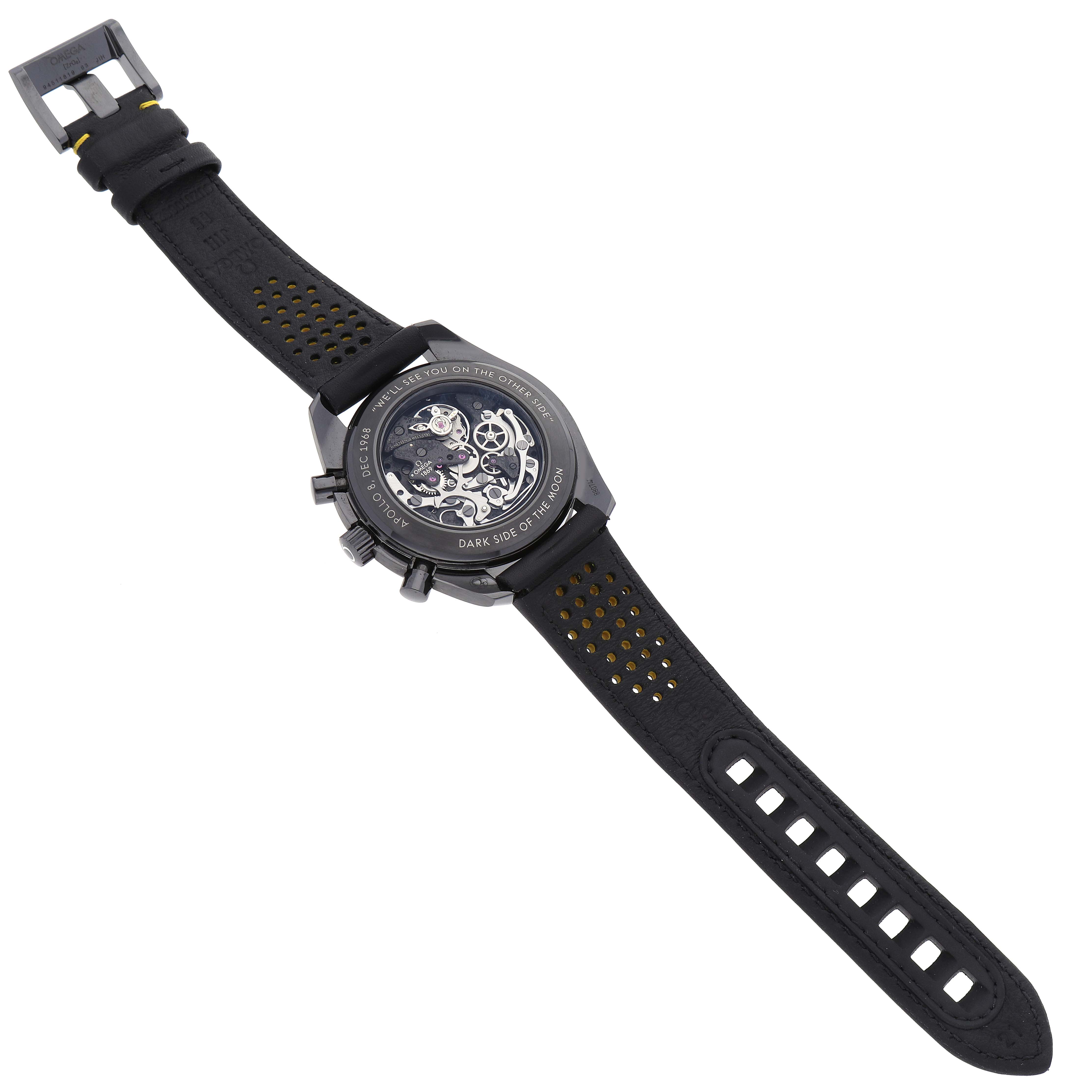 The image shows the Omega Speedmaster 311.92.44.30.01.001 Men's Ceramic Black Dial 311.92.44.30.01.001 Men's Ceramic Black Dial watch from its back, highlighting its open case back and watch straps.
