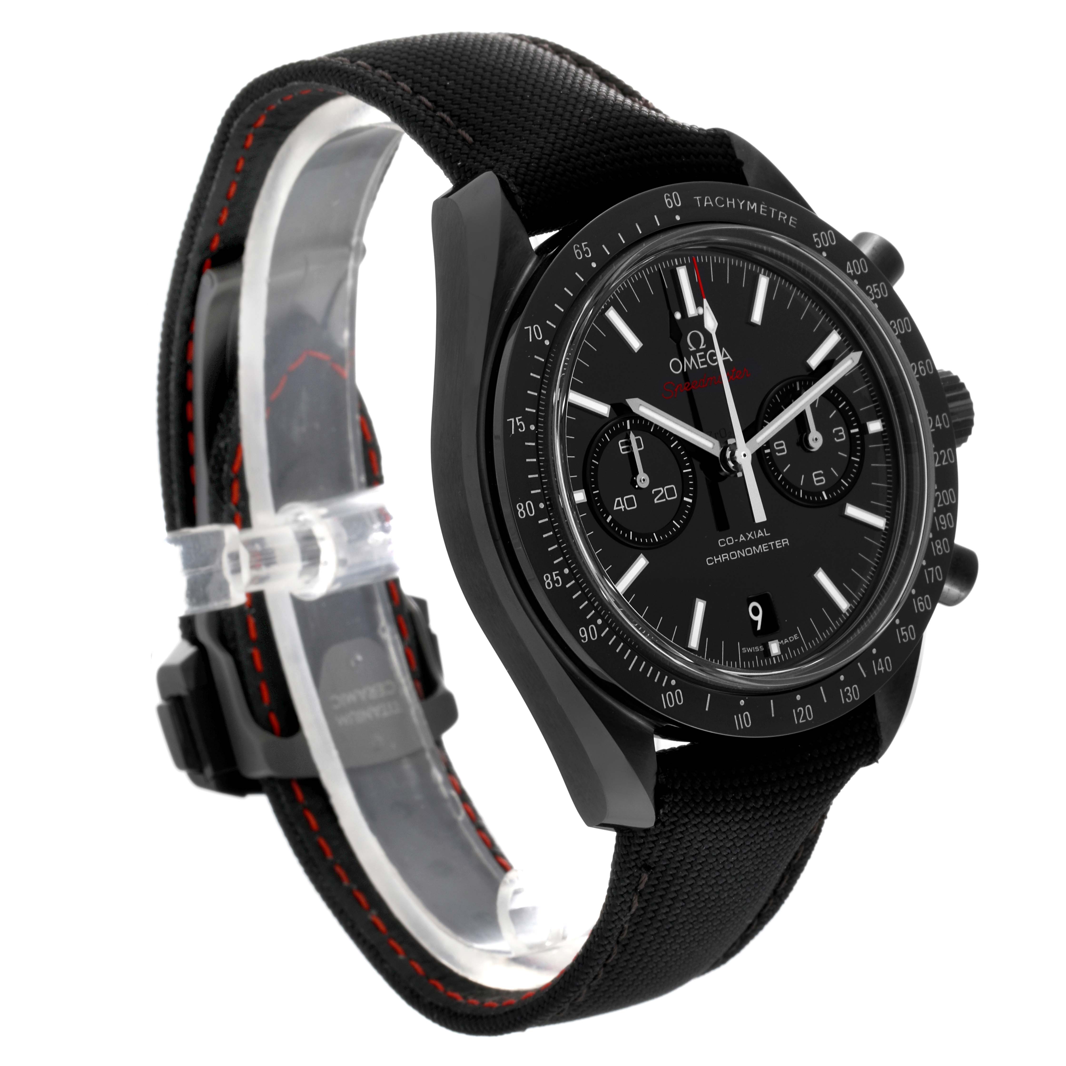 The Omega Speedmaster 311.92.44.51.01.003 Men
s Ceramic Black Dial 311.92.44.51.01.003 Men
s Ceramic Black Dial watch is shown from a side angle, highlighting the face, bezel, and fabric strap with stitching.