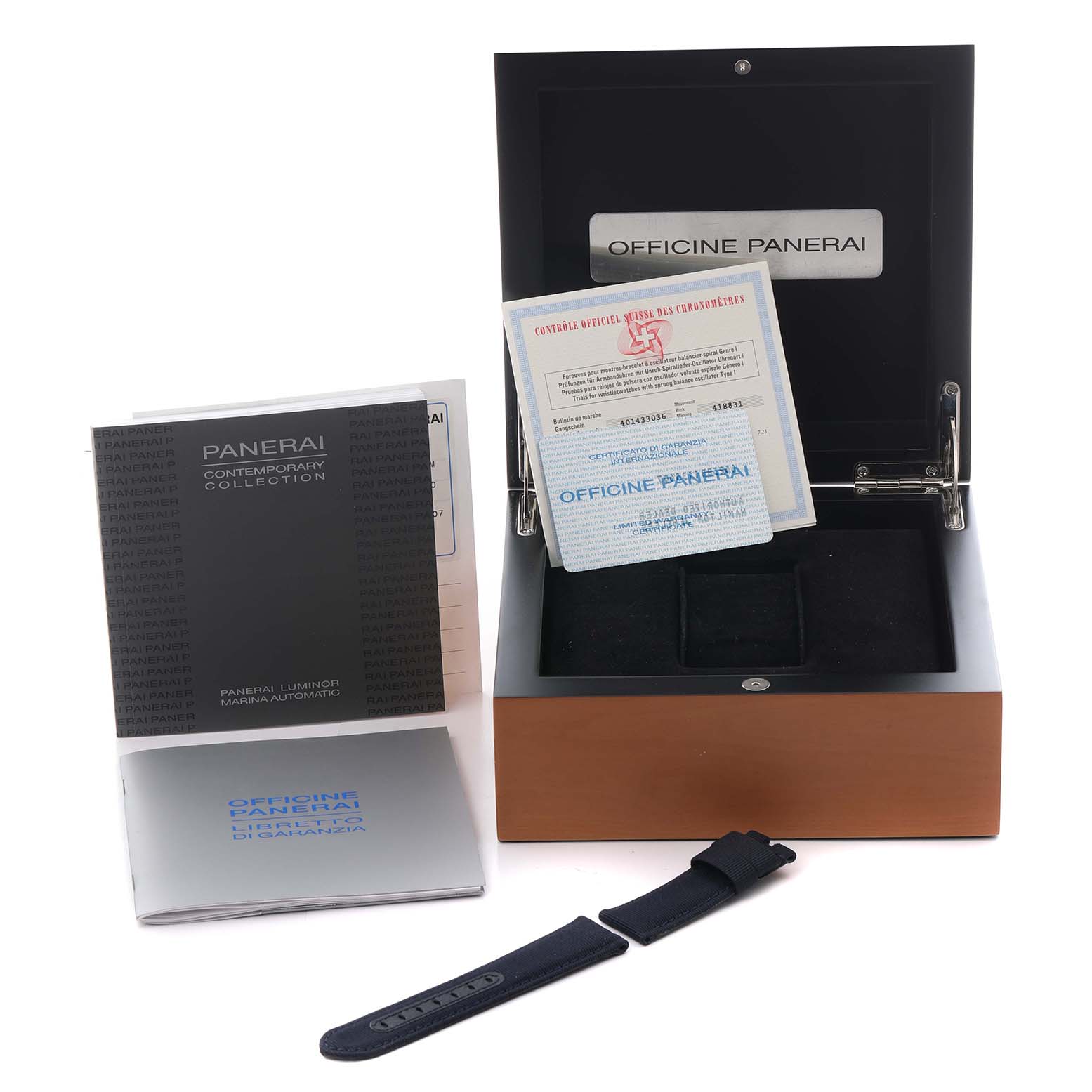 The image shows a Panerai Luminor PAM00119 Men
s Stainless Steel Blue Dial PAM00119 Men
s Stainless Steel Blue Dial watch box, manuals, warranty card, and an additional strap, viewed from the front.