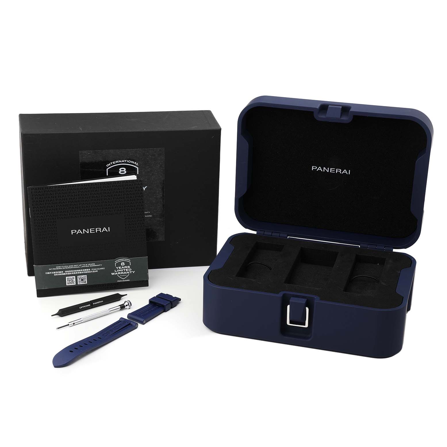 The image shows a Panerai Luminor PAM01157 Men's Stainless Steel Blue Dial watch case, tools, booklet, and an extra strap from a top-down angle.
