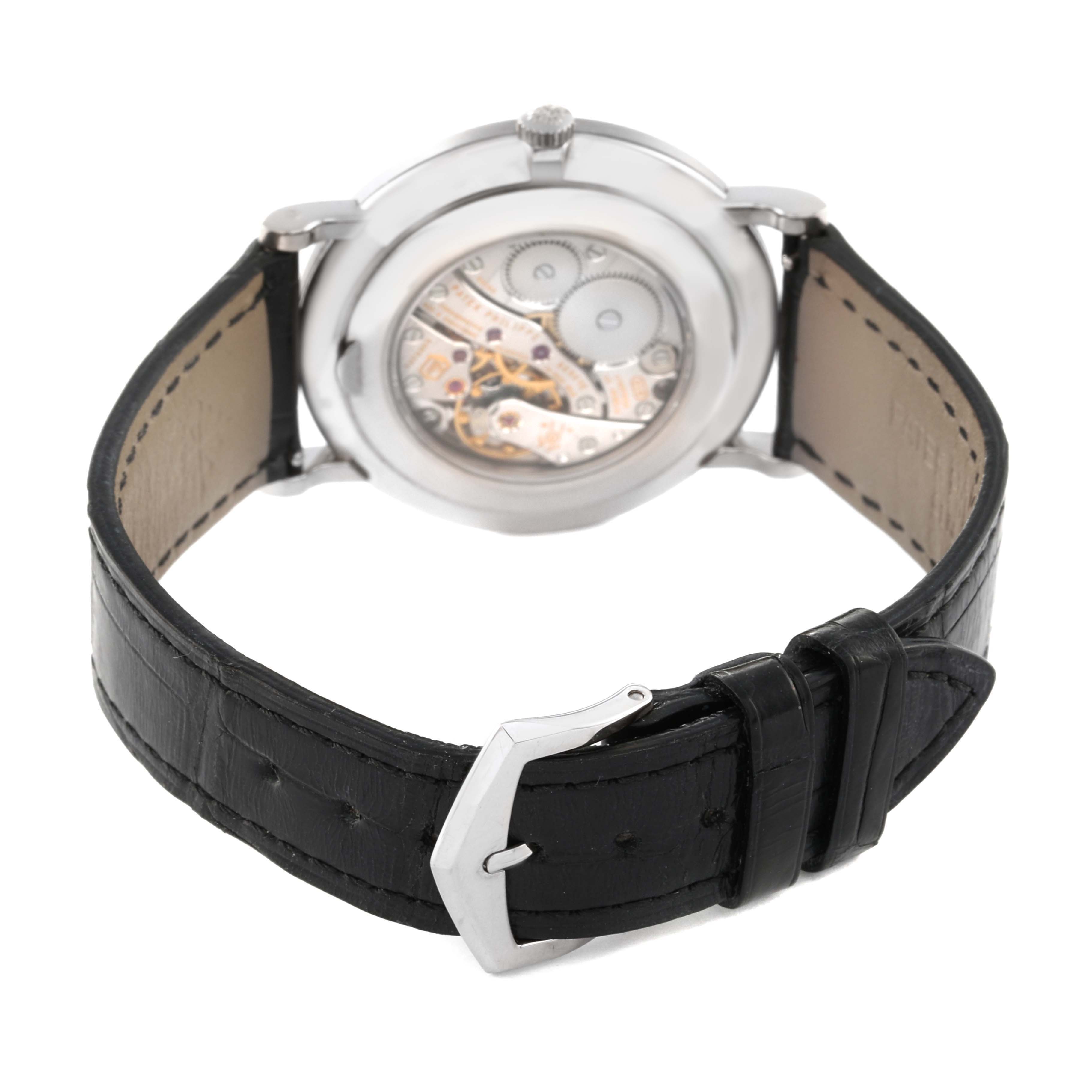 The image shows the back view of a Patek Philippe Calatrava 5119G-001 Men's White Gold White Dial 5119G-001 Men's White Gold White Dial watch, highlighting its leather strap and visible mechanical movement.