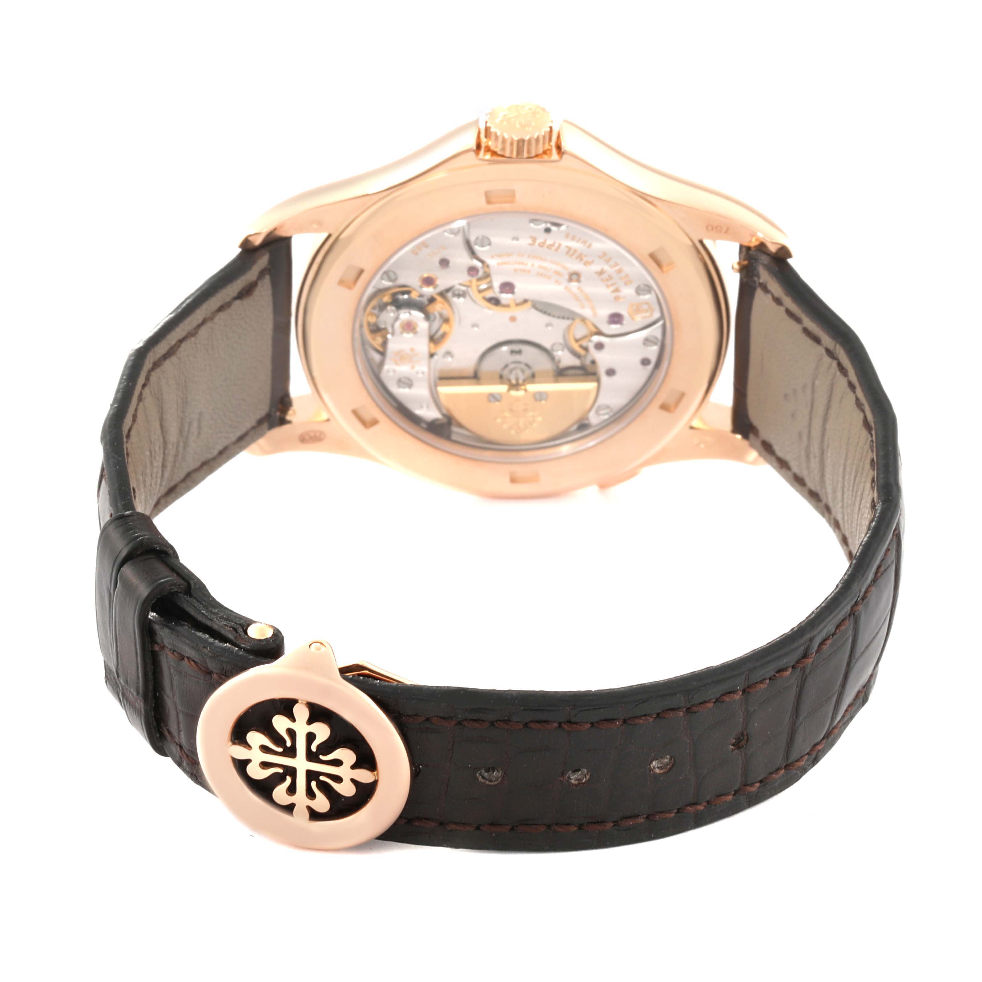 This image shows the back case and movement of the Patek Philippe Complications 5130R-001 Men's Rose Gold Silver Dial 5130R-001 Men's Rose Gold Silver Dial watch, along with its leather strap and clasp.
